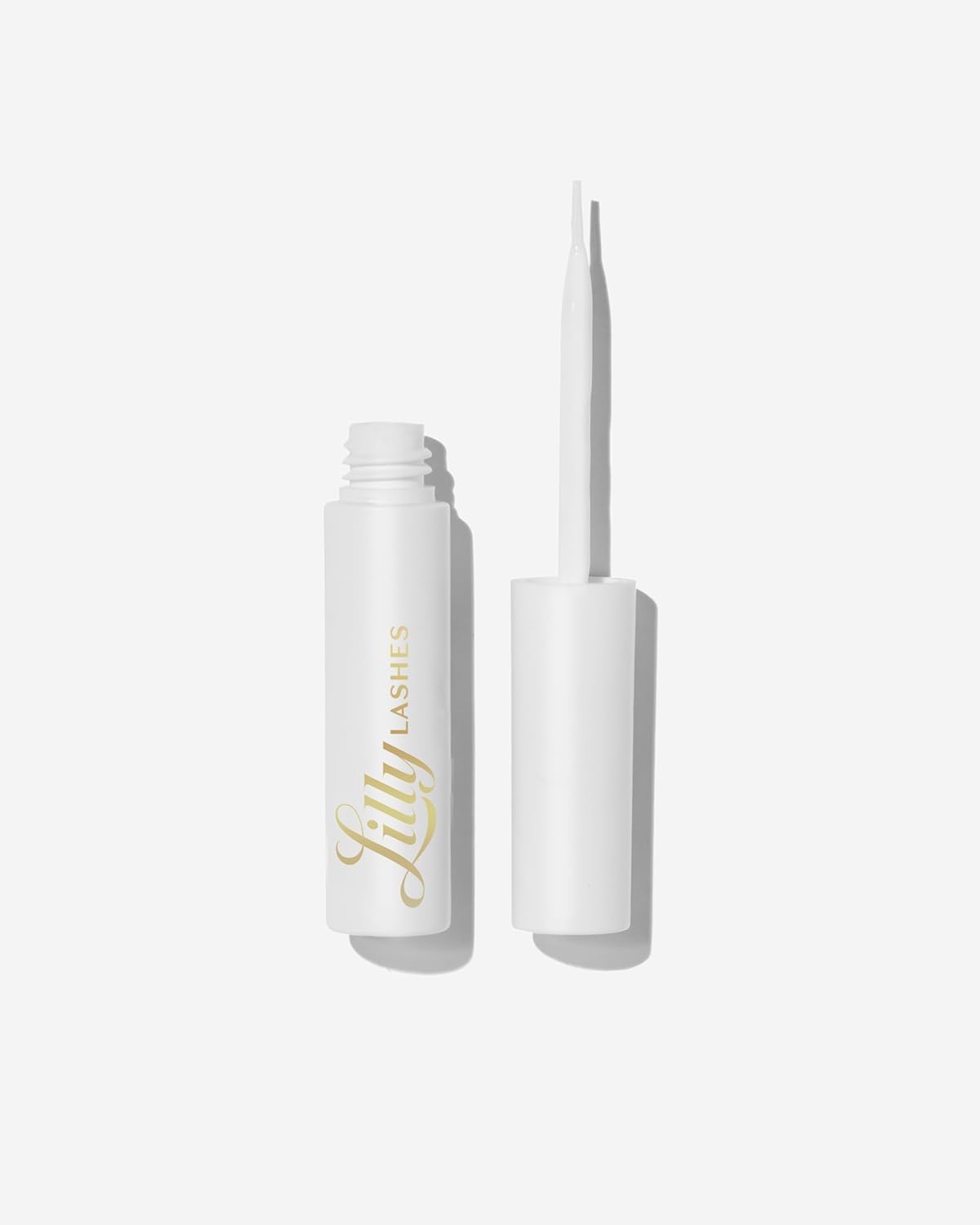 Showcases the product's sleek white packaging and applicator brush to highlight its premium quality and ease of use.
