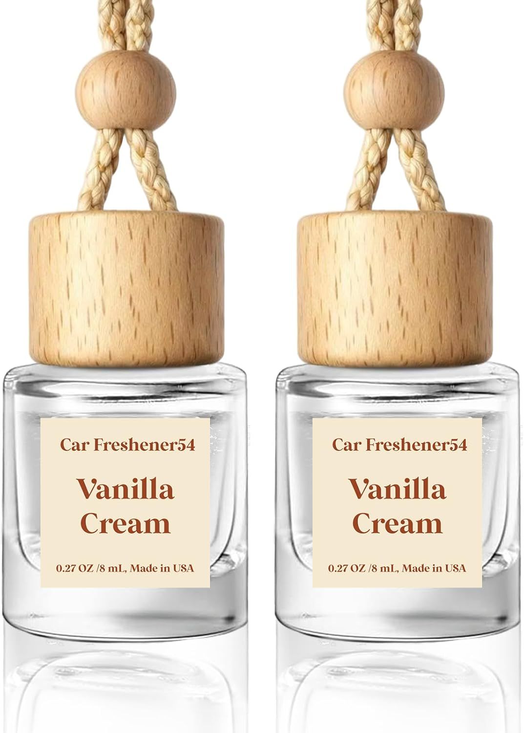 Showcases the product design and packaging to highlight its natural wood elements and glass bottle. Displays the product label to communicate the scent (Vanilla Cream) and brand name (Car…