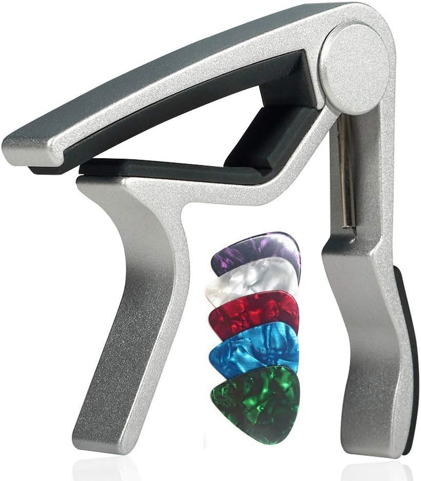 Shows the guitar capo along with all included guitar picks in multiple colors to communicate exactly what the buyer will receive in their purchase.