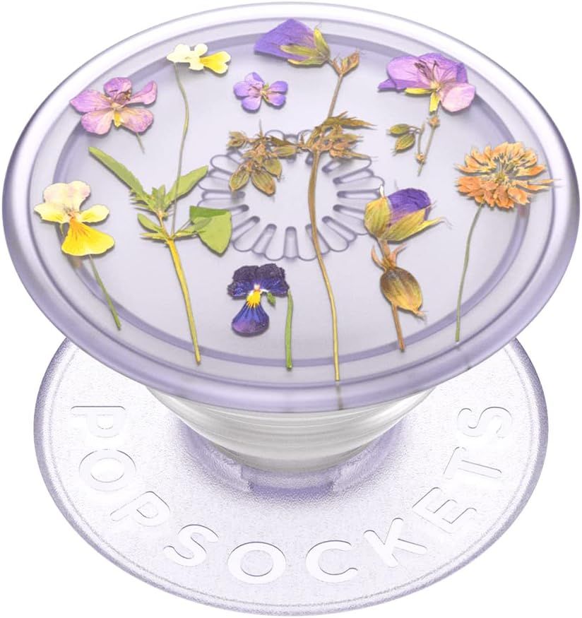 Shows the core product, a PopSocket phone grip with an embedded pressed flower design, clearly displaying its aesthetic appeal and decorative nature. Uses a subtle drop shadow beneath the product to…