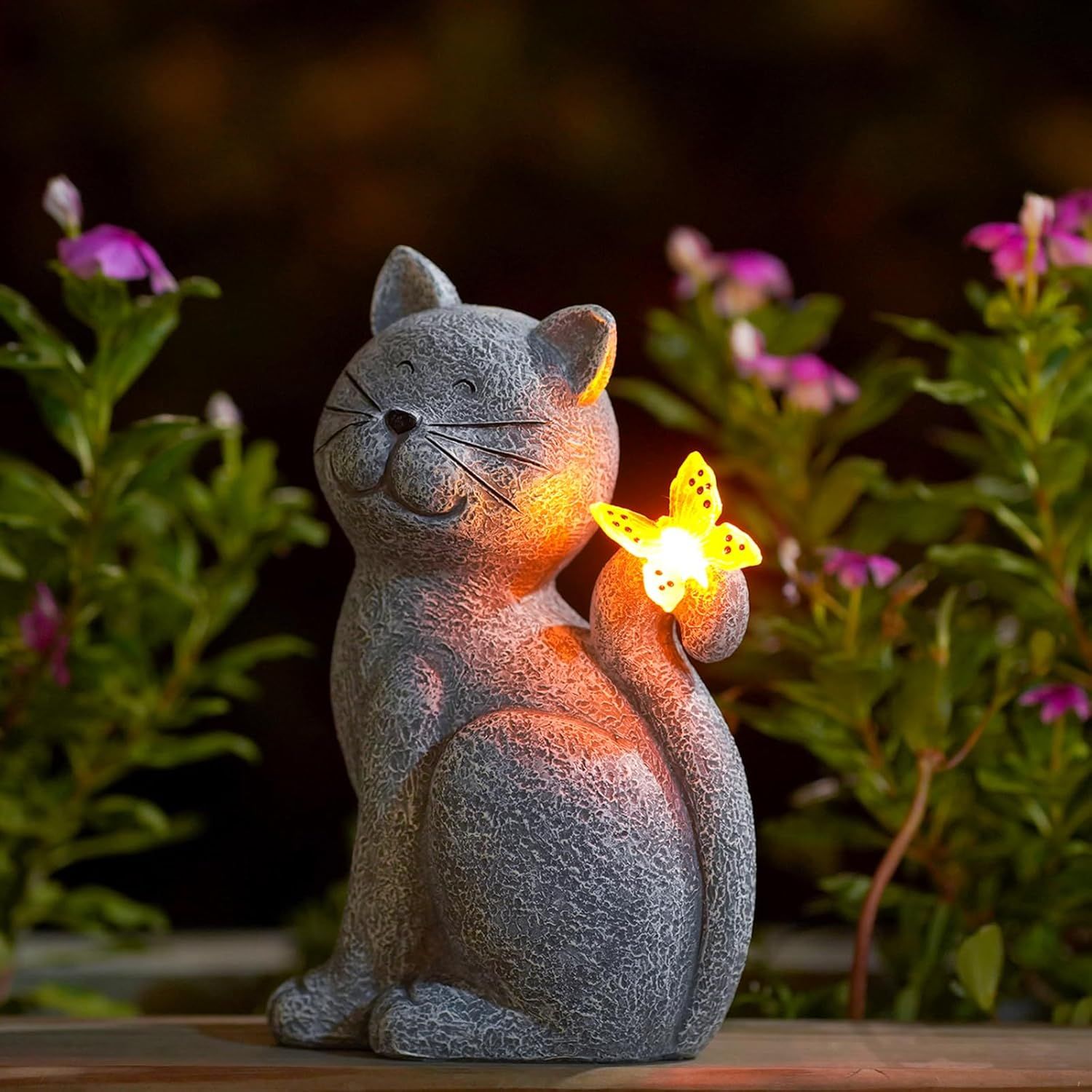 Shows the core product, a decorative cat figurine with an illuminated flower, to communicate its charming design and lighting feature for garden or home decor. Displays the product in a natural…