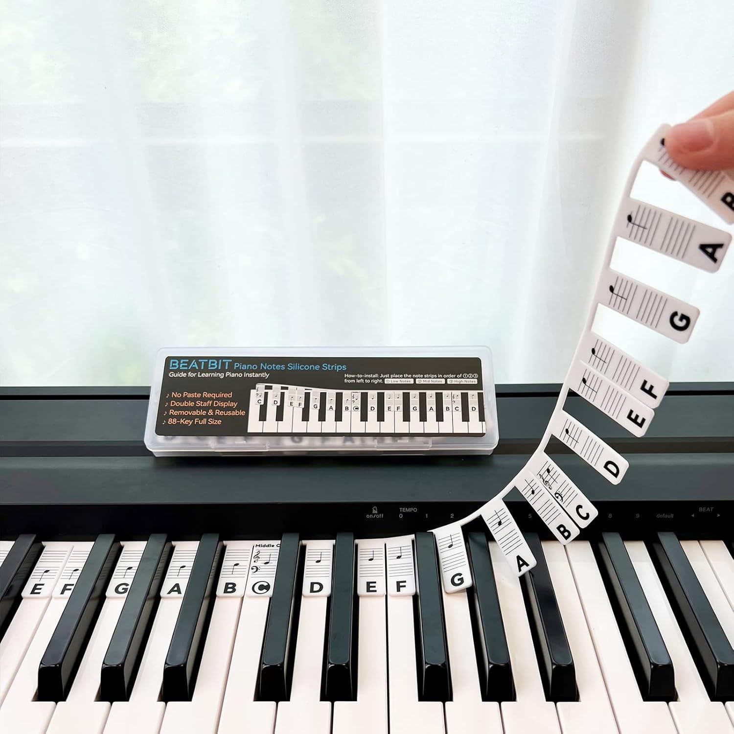 Shows the core product—silicone piano note strips and labels—in use on a keyboard to demonstrate how they help beginners learn piano keys and notes instantly. Demonstrates the product actively…