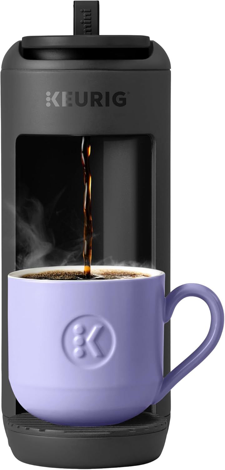 Shows the coffee maker actively brewing coffee into a mug, demonstrating how the product works and what it does in real use. Displays the core sellable Keurig coffee maker product clearly with a mug…