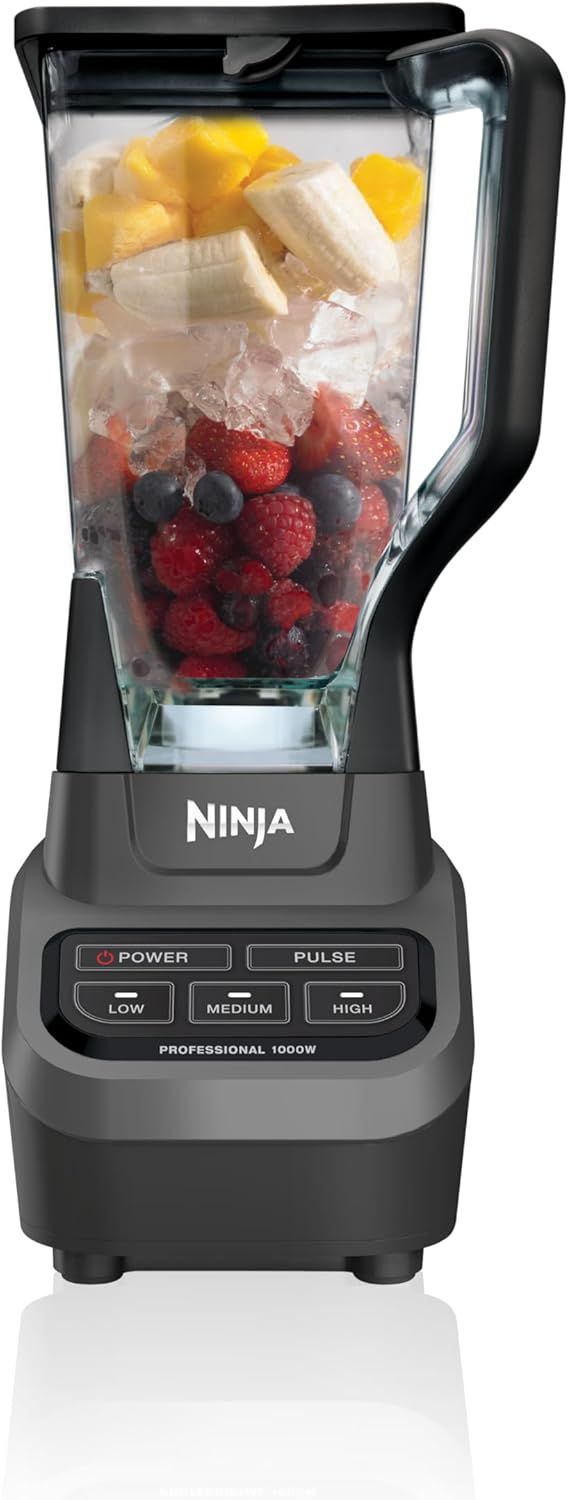 Shows the Ninja blender loaded with fresh fruit and ice to demonstrate its intended use for making smoothies and blended drinks, reassuring shoppers about its capacity and functionality.…