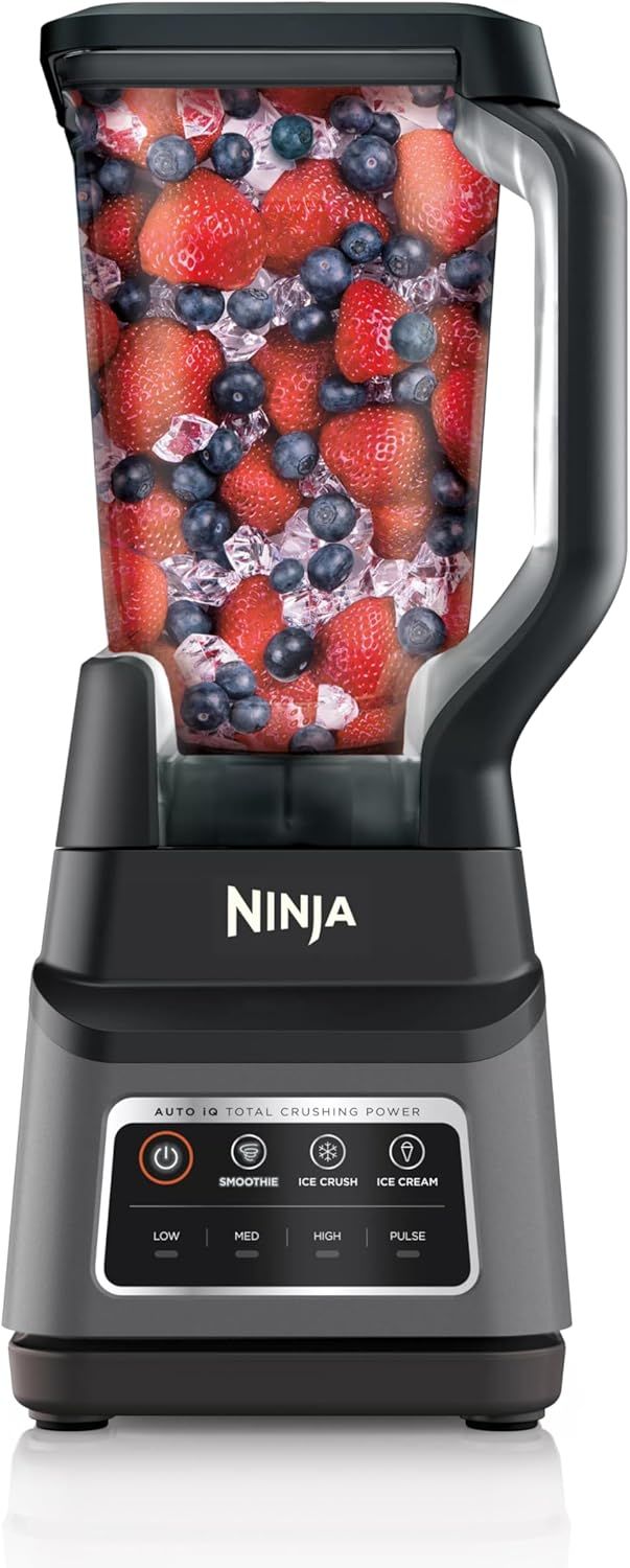 Shows the Ninja blender as the core product with fresh fruit and ice inside the pitcher to demonstrate its intended use for making smoothies and frozen drinks. Demonstrates the blender ready to…