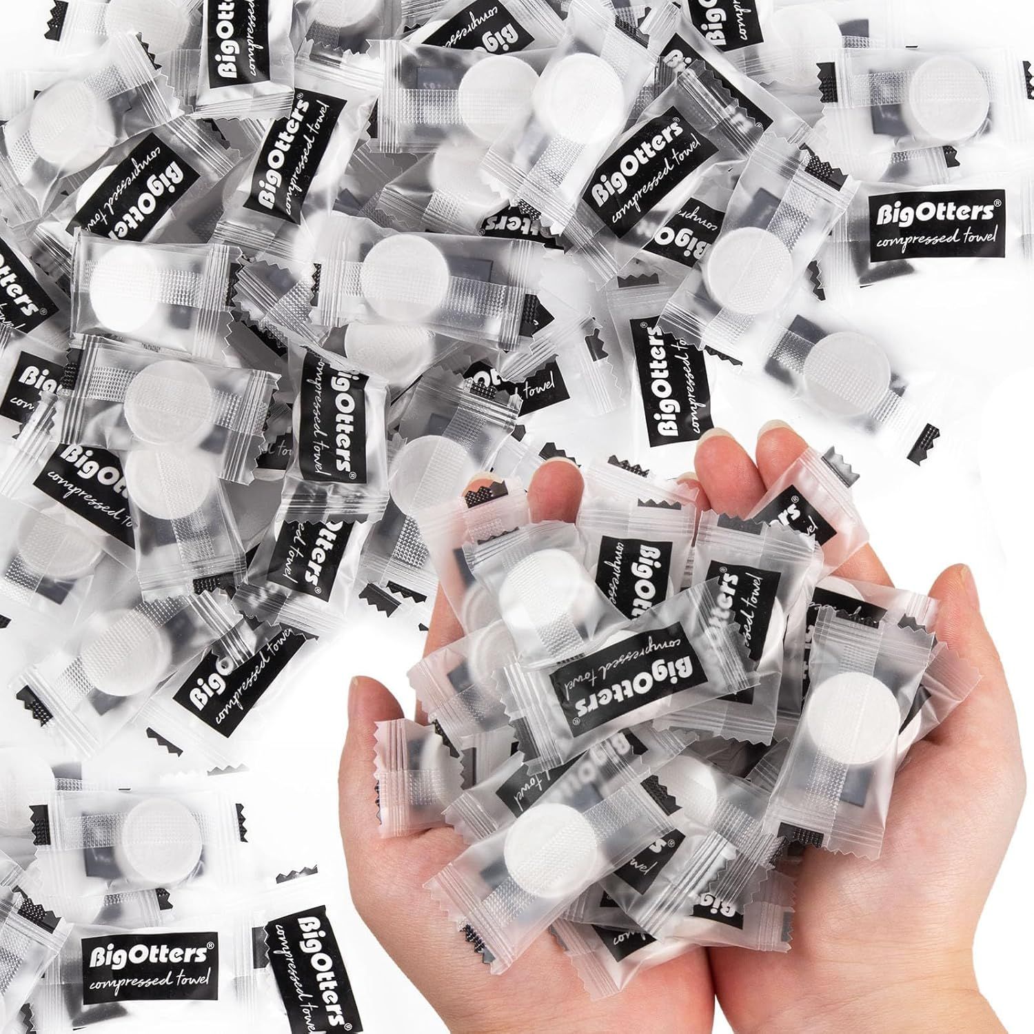 Shows the core product—individually wrapped compressed towels—to communicate what the buyer receives and the convenient single-use packaging format. A hand holding multiple towel packets provides…