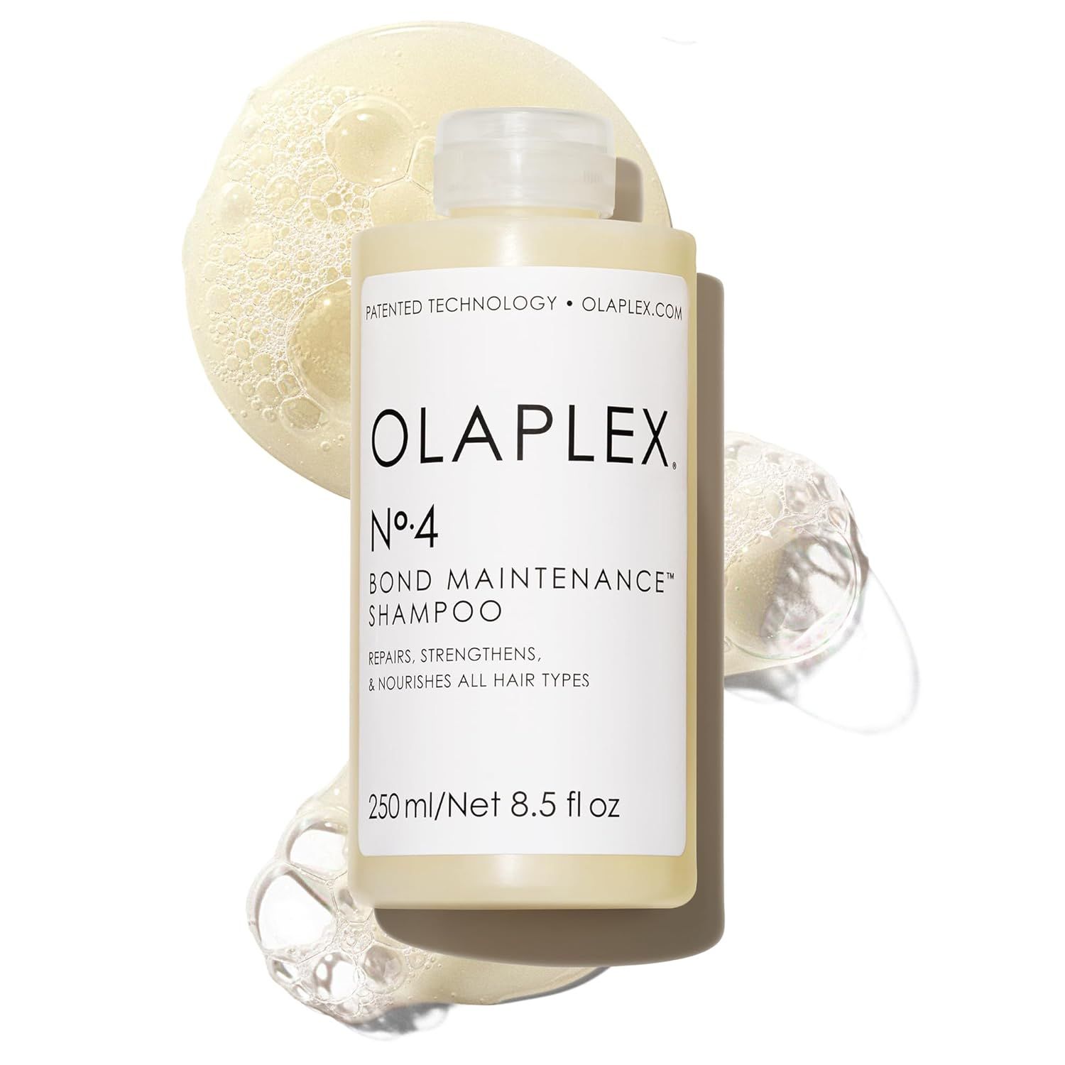 Displays the OLAPLEX No.4 Bond Maintenance Shampoo bottle clearly to show the product branding, formula benefits (repairs, strengthens, nourishes), and size, helping shoppers identify the specific…
