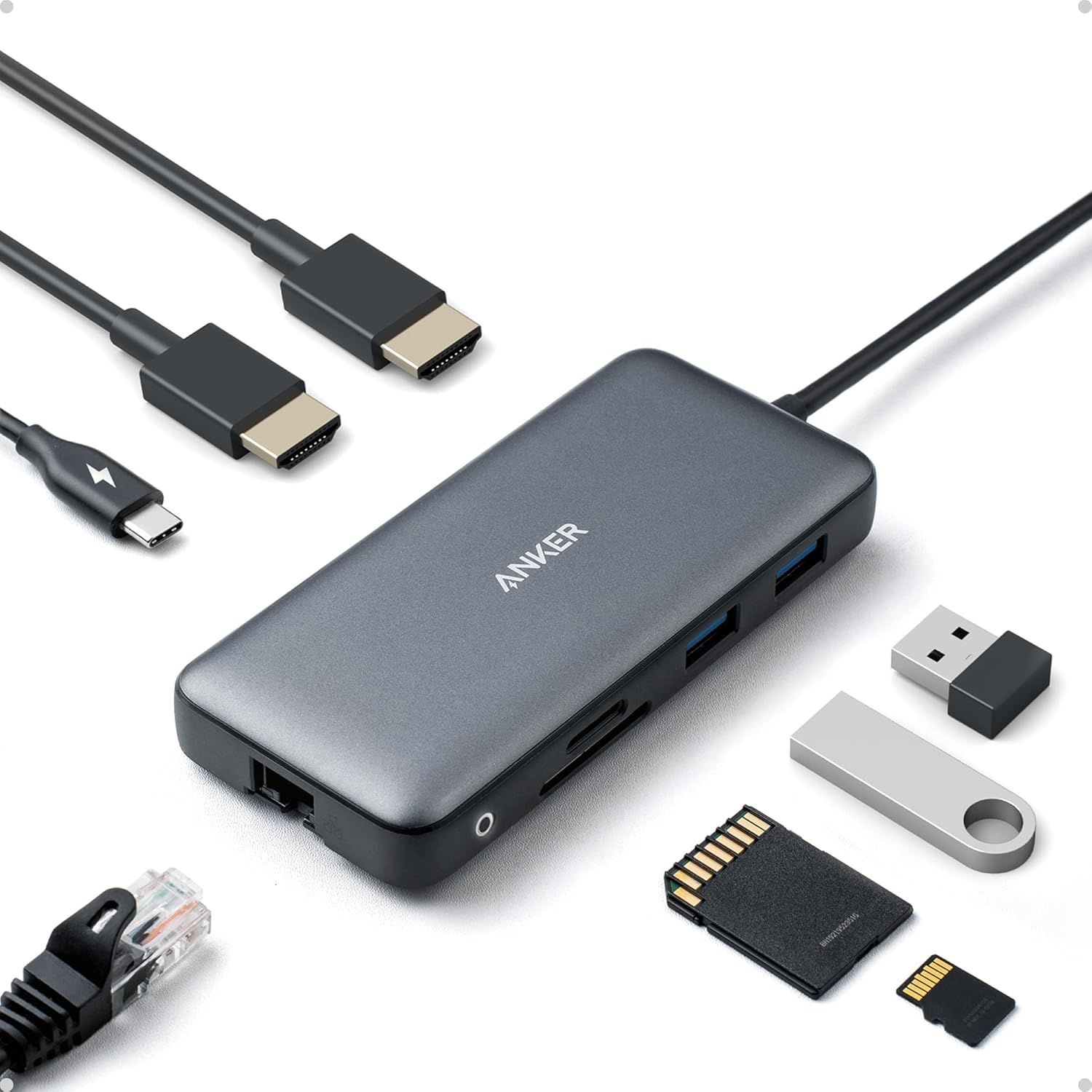 Displays the core product, an Anker USB-C hub, along with all the cables and accessories that demonstrate its connectivity capabilities and compatibility with various devices and storage media.…