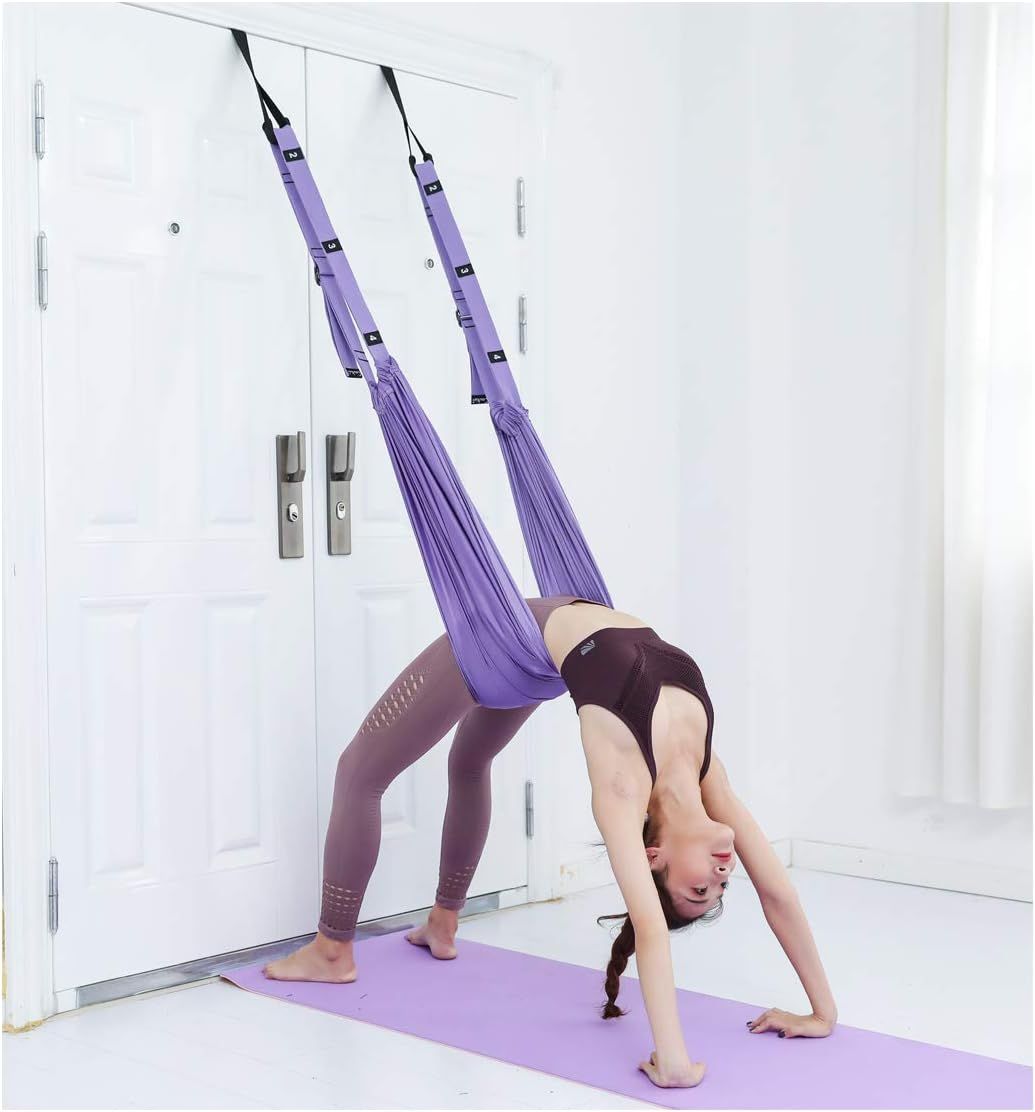 Shows a person actively using the aerial yoga swing to demonstrate how the product works and provide scale context for shoppers considering the product for their own fitness practice. Demonstrates…