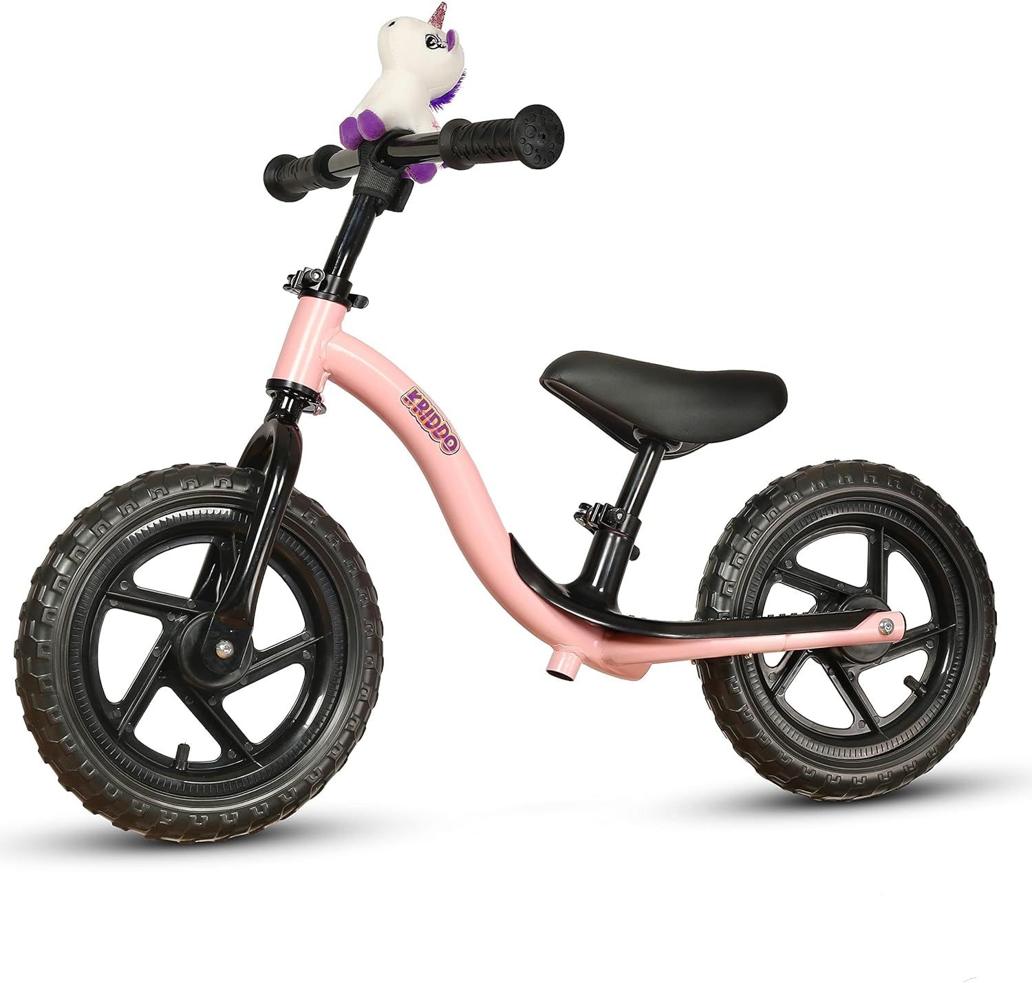 Displays the core product, a pink balance bike with black wheels and a decorative unicorn toy on the handlebars, clearly showing what the buyer will receive. Shows the included unicorn plush toy…