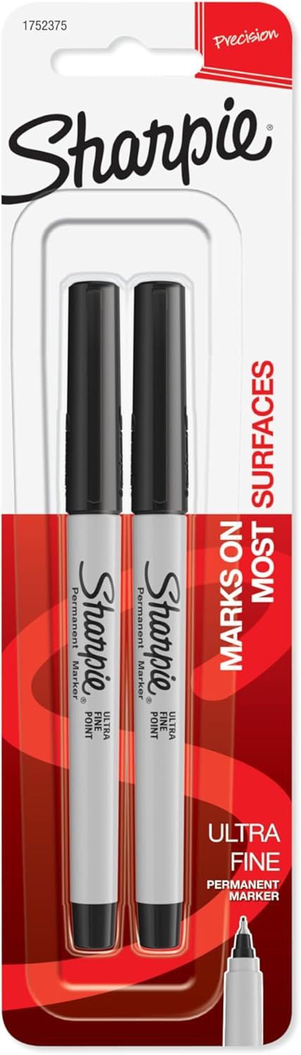 Displays the core product, two Sharpie ultra fine point permanent markers in retail packaging, clearly showing the brand and product type to help shoppers identify what they are purchasing. Shows…