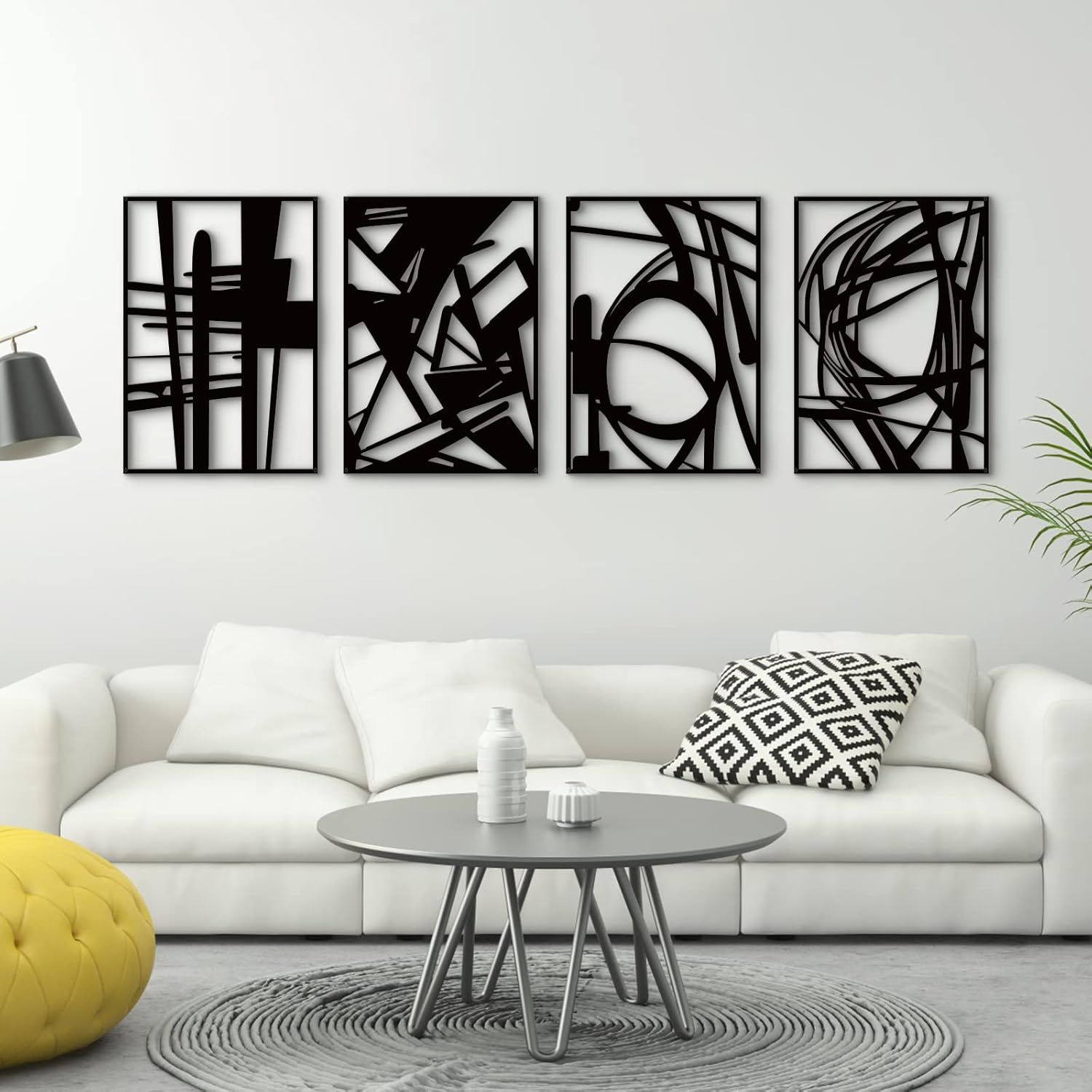 Shows the core product, a set of four black framed abstract metal wall art panels, displayed in a lifestyle setting to help shoppers visualize the complete set and its aesthetic appeal. Demonstrates…