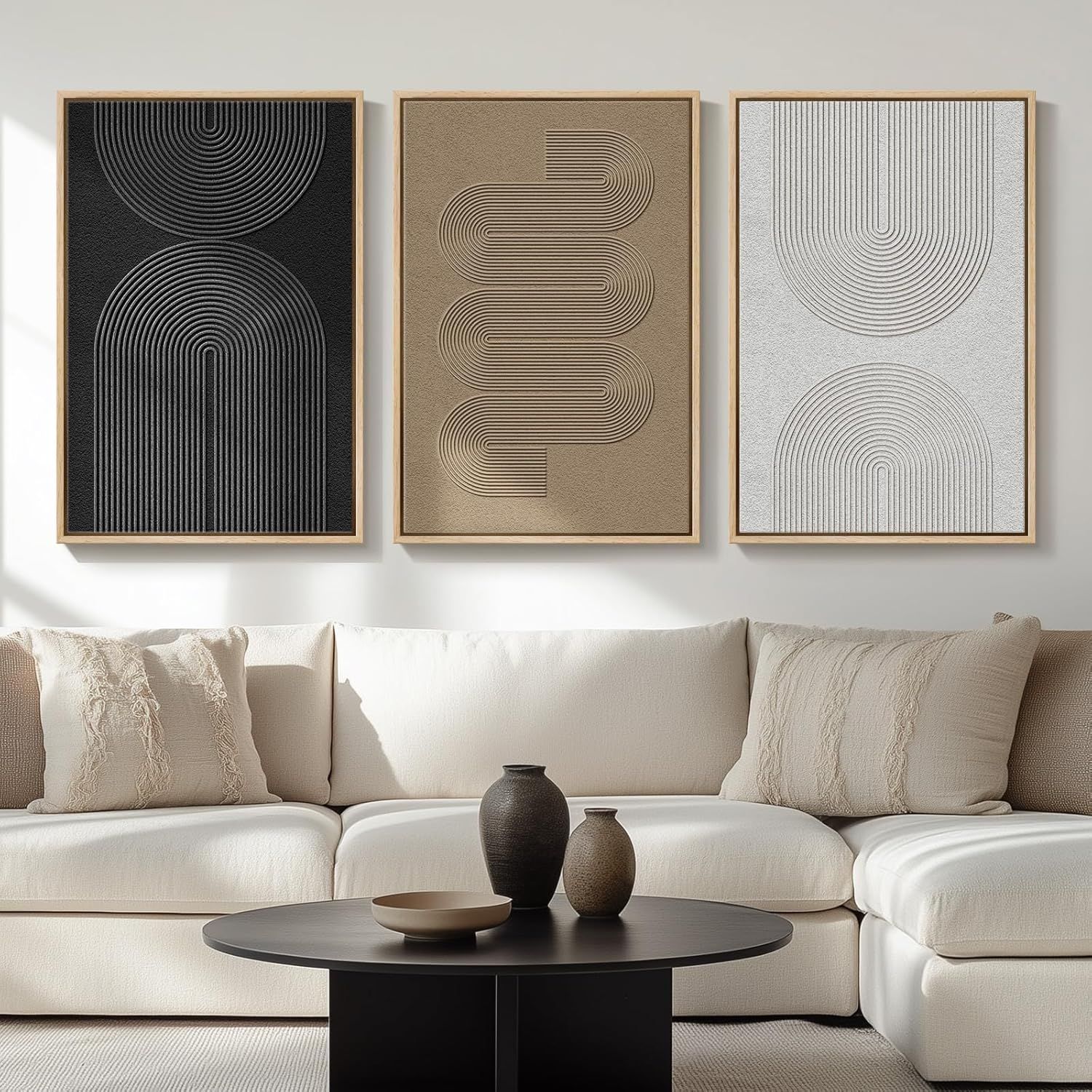 Shows the wall art set displayed in a styled living room environment to help shoppers visualize how the product will look in their own home and understand its scale and aesthetic appeal. Displays…