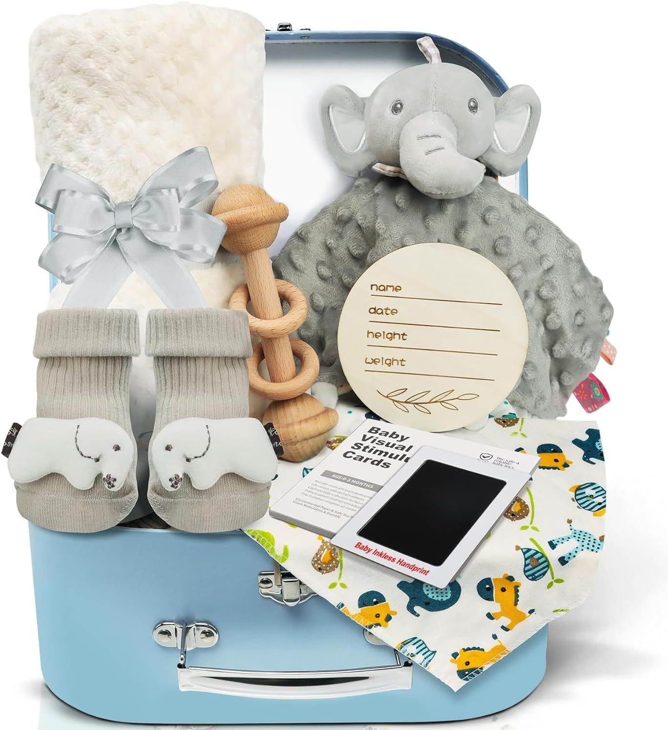 Displays a complete baby gift basket with all included items (blanket, elephant toy, teether, booties, milestone cards, and keepsake disc) to show shoppers the full value and variety of the bundle.…
