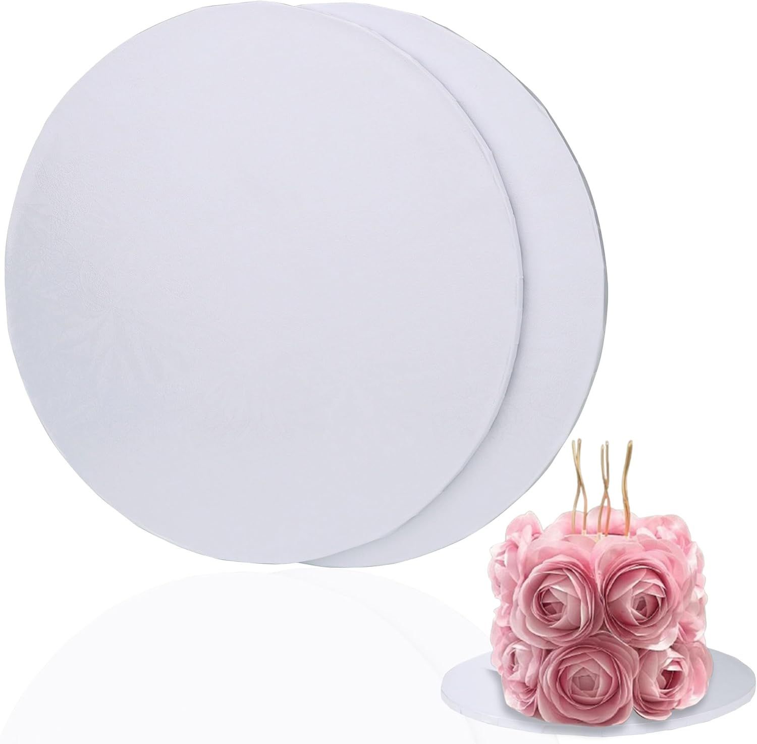 Shows the core product clearly - two white round cake boards of different sizes - to communicate what the buyer will receive. The decorative pink roses demonstrate scale and typical use case.
