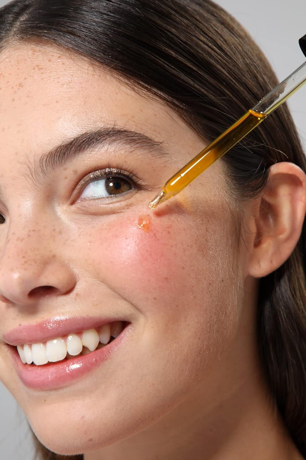Demonstrates the proper technique for applying an eyelash growth serum or treatment to the lash line.