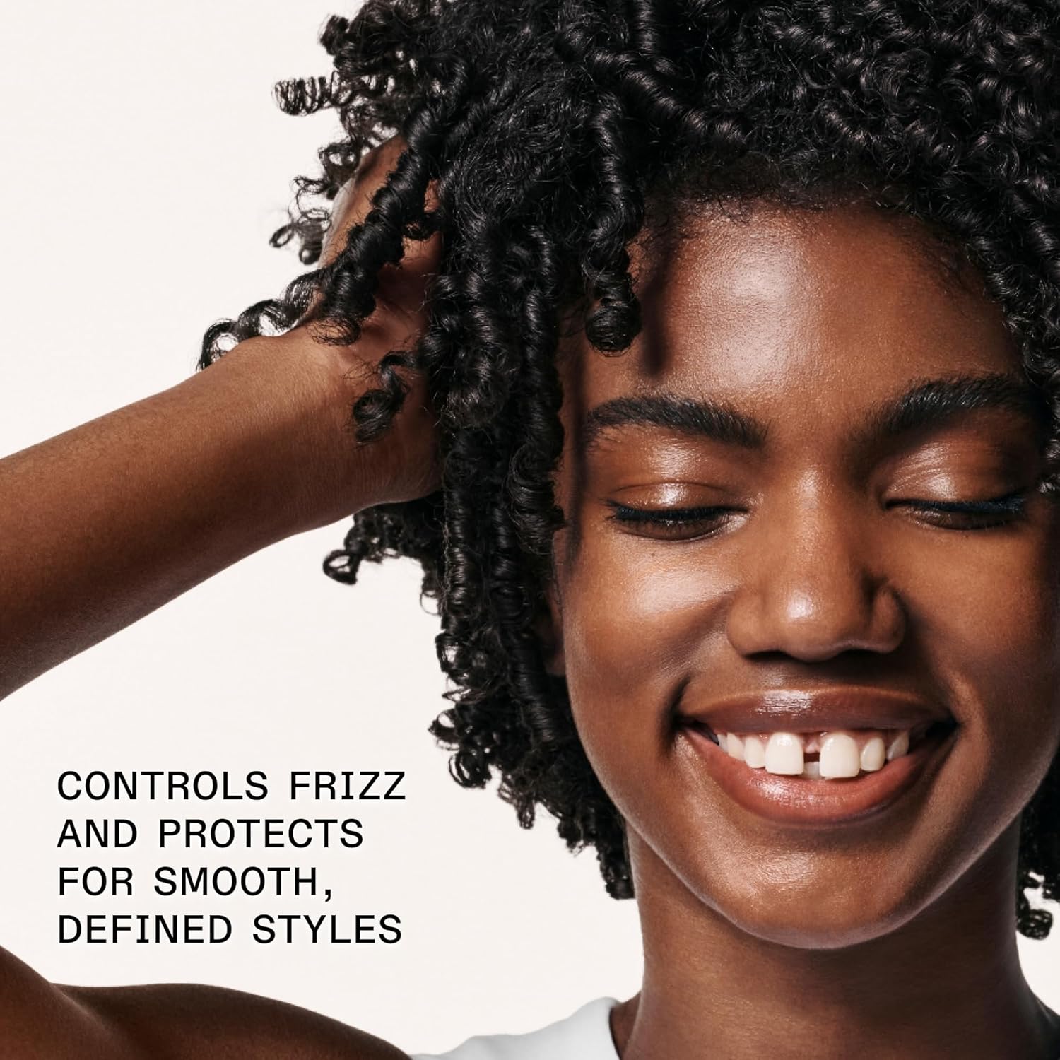 Highlights the product's ability to control frizz and protect hair for smooth, defined styles.