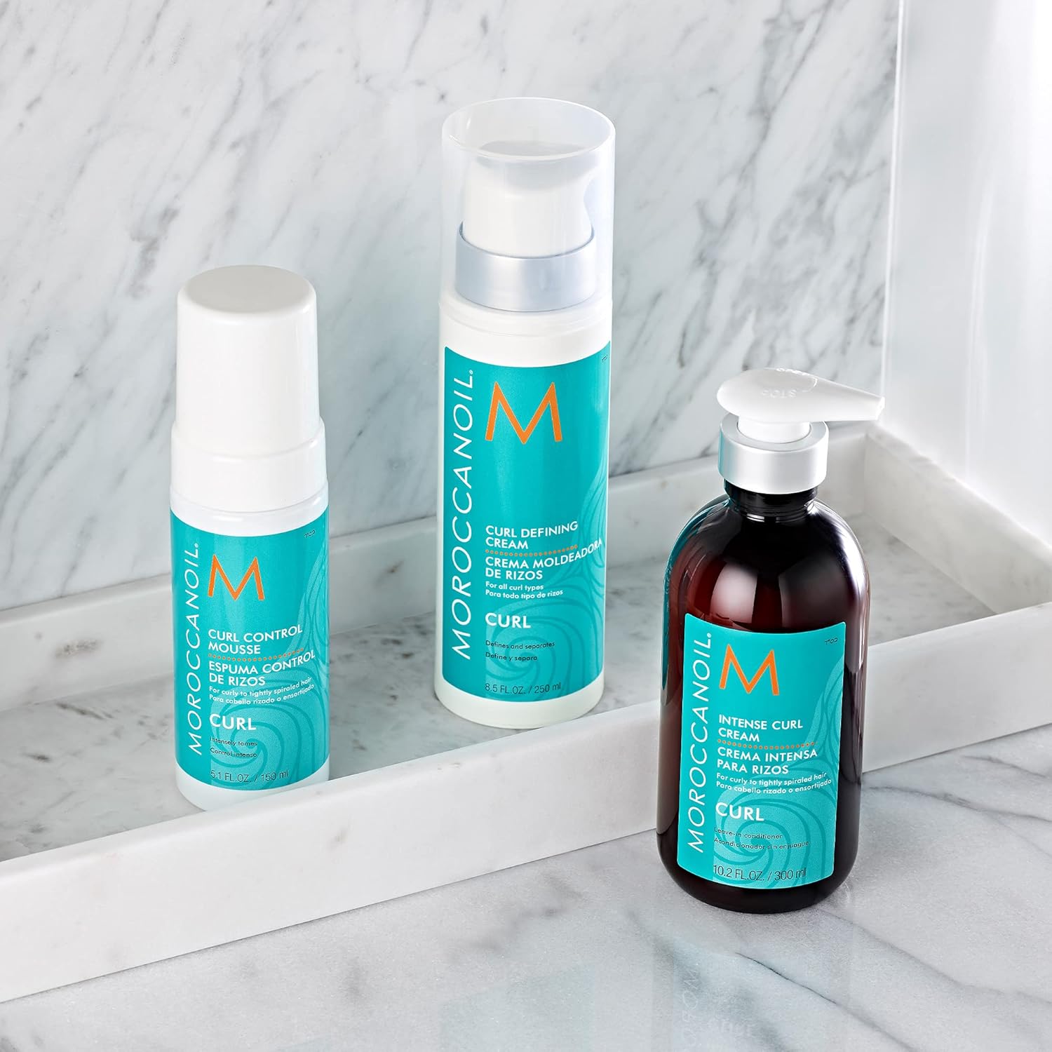 Shows the different curl-enhancing products included in the line or kit to manage curly hair.