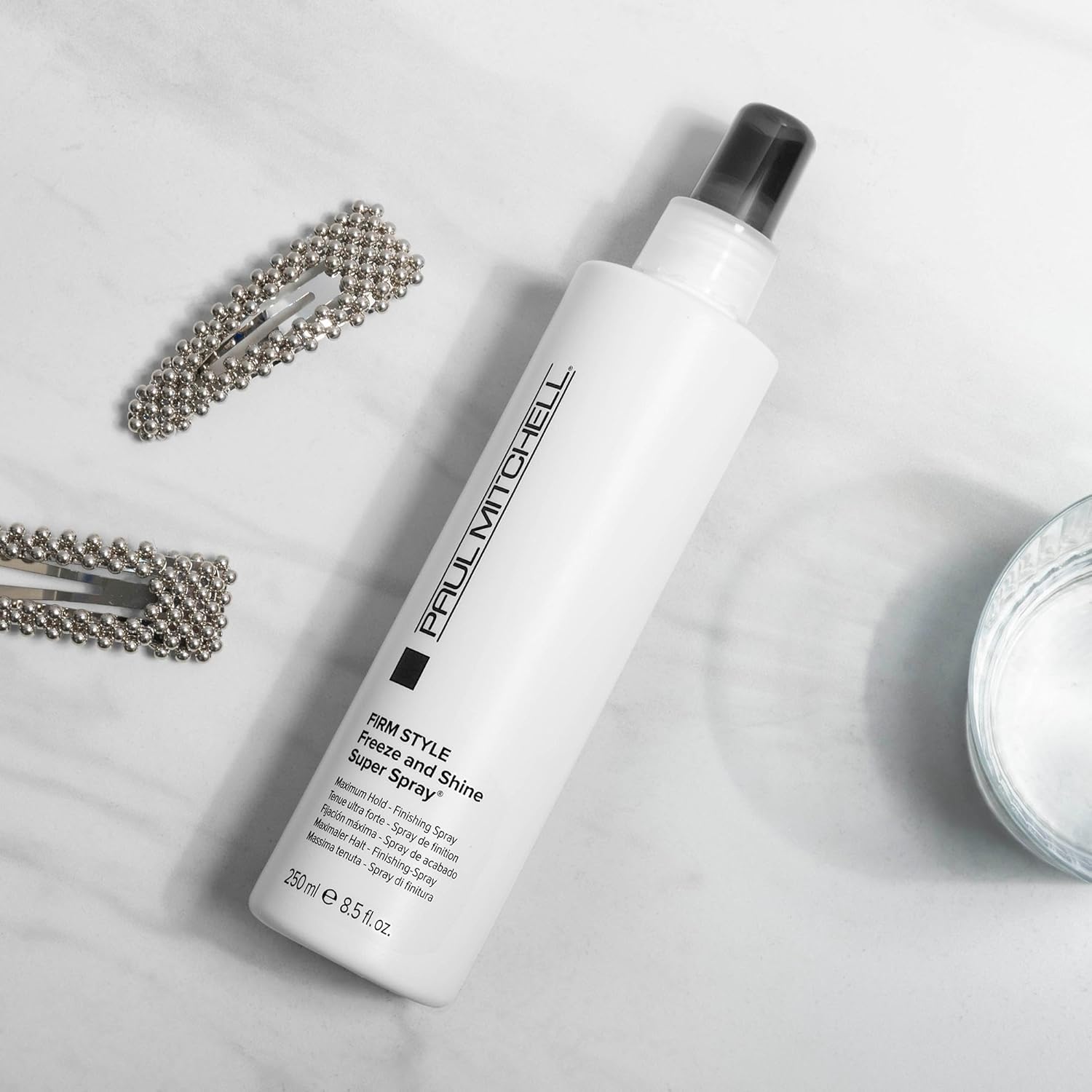 Highlights the product's ability to provide a firm, long-lasting hold with a shiny finish for styled hair.