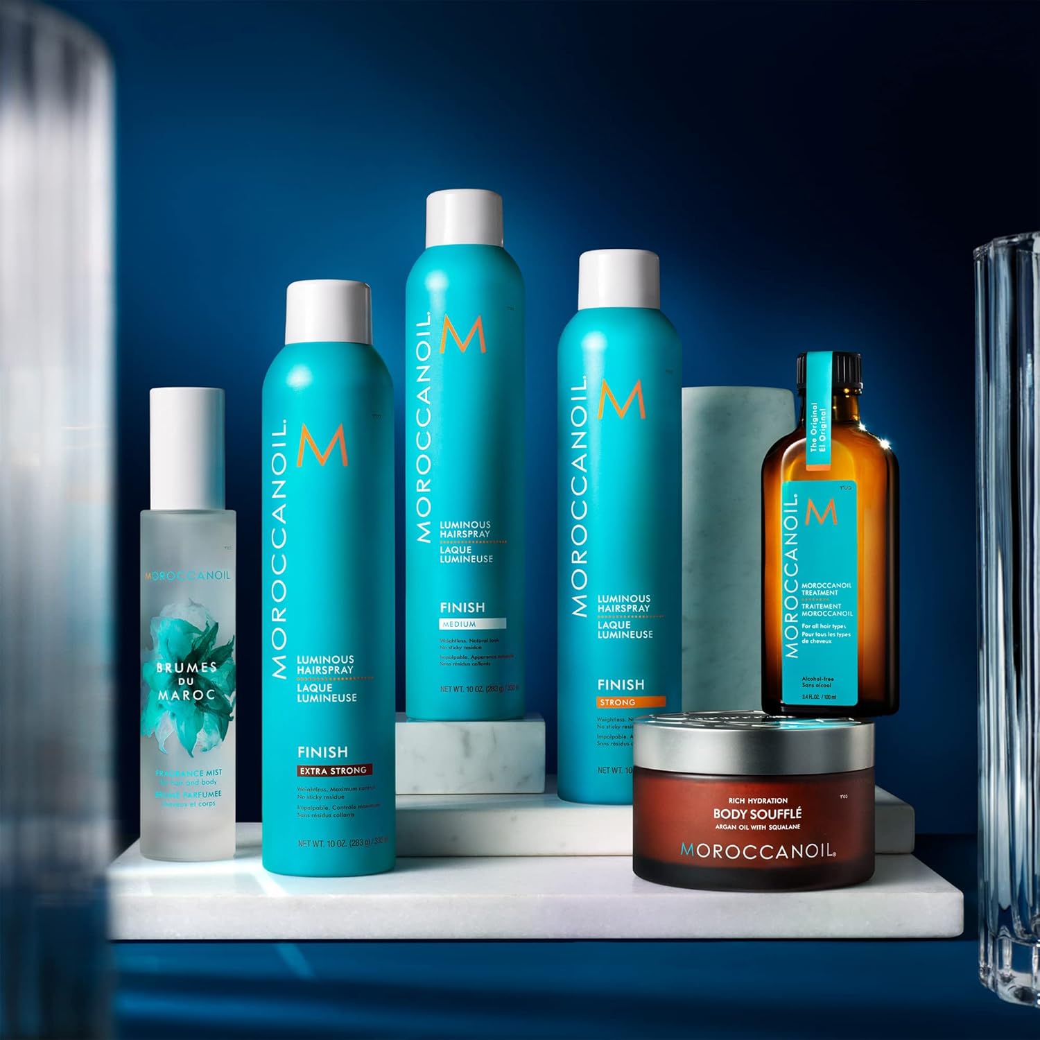 Shows the full range of products included in the Moroccanoil line, highlighting the different hair sprays, treatments, and body care items.