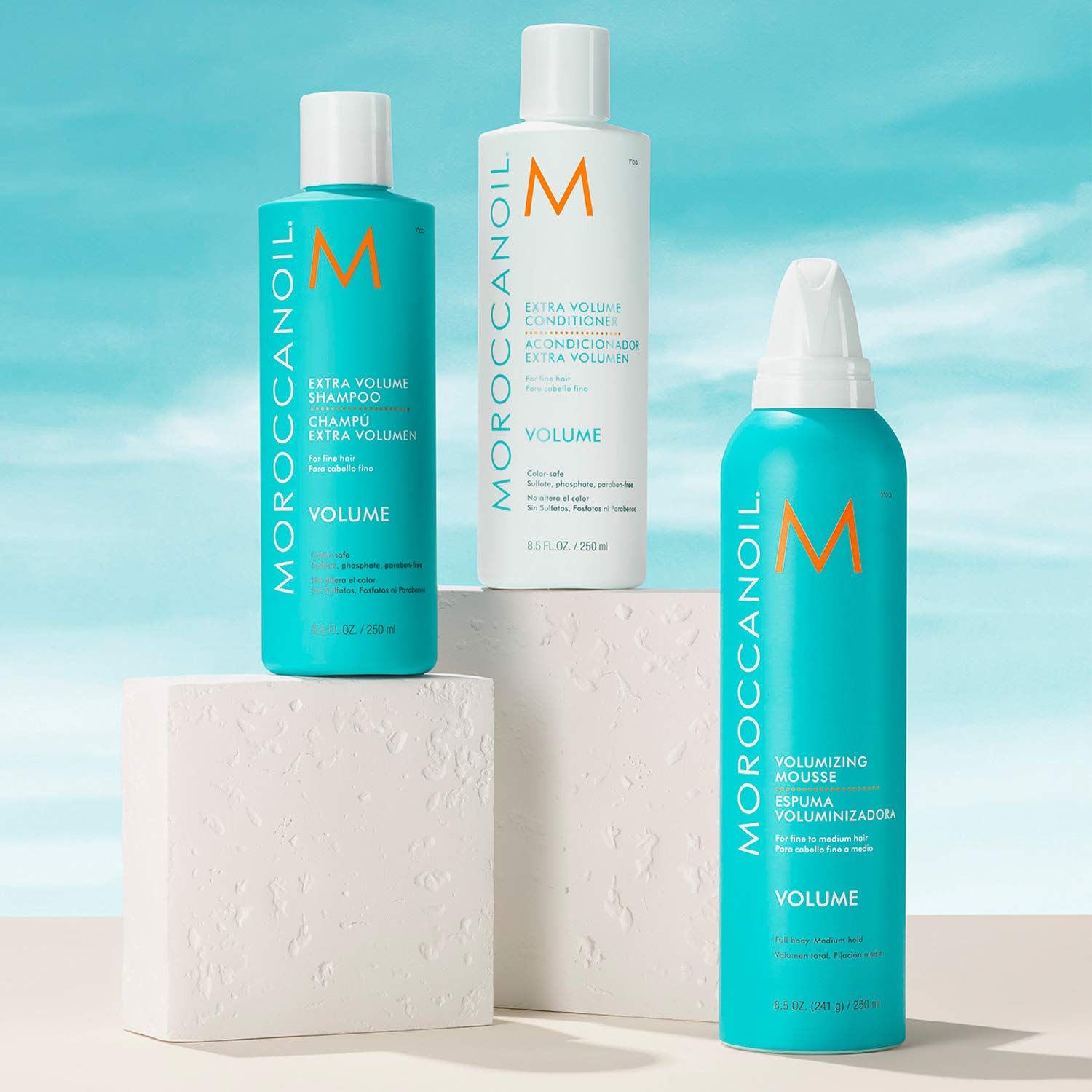 Shows the complete hair care system included in the purchase, consisting of a shampoo, conditioner, and volumizing mousse for adding volume and body to hair.