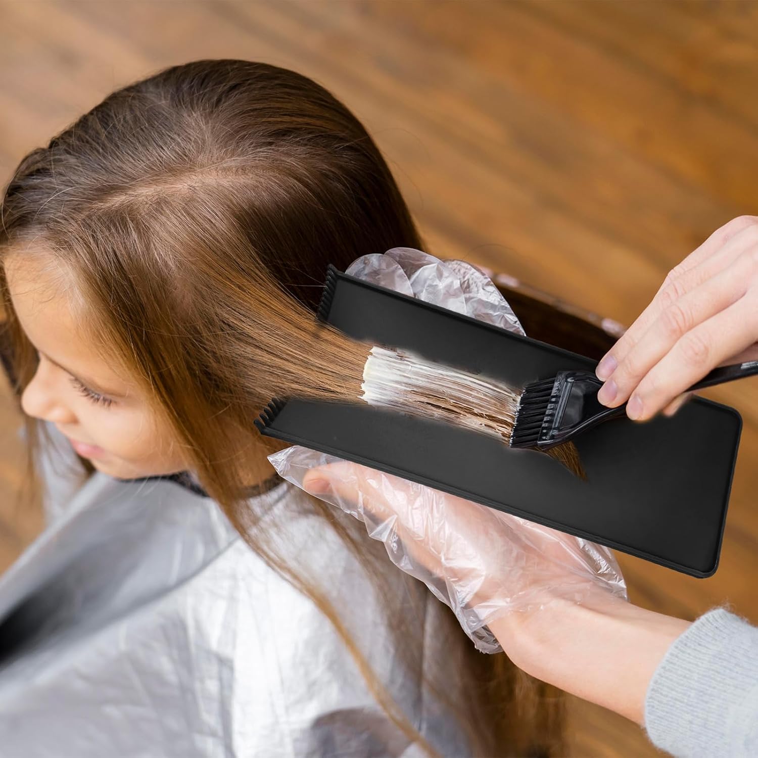 Demonstrates the proper way to apply hair color or dye using the product brush.