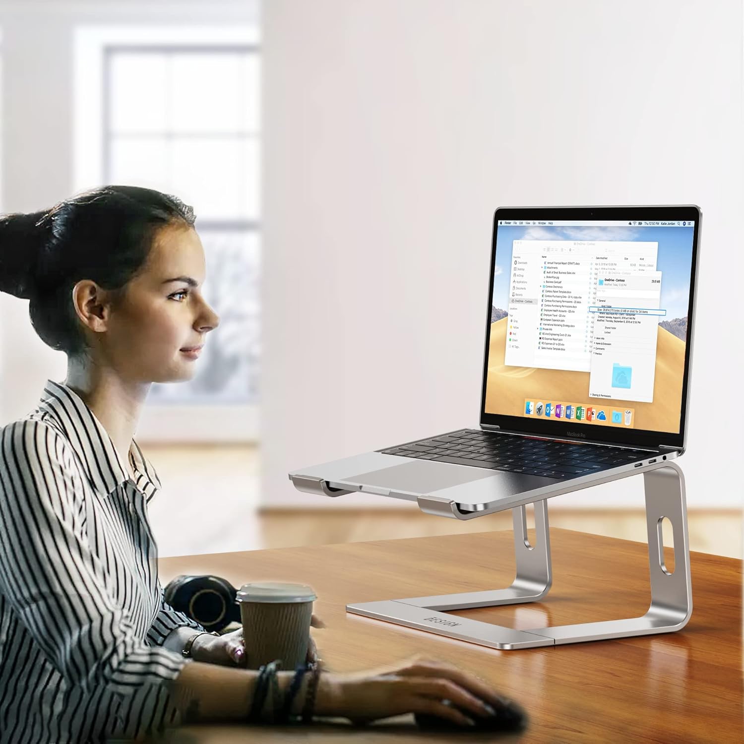 Demonstrates how the laptop stand can be used to create an ergonomic workspace, improving posture and comfort for extended computer use.