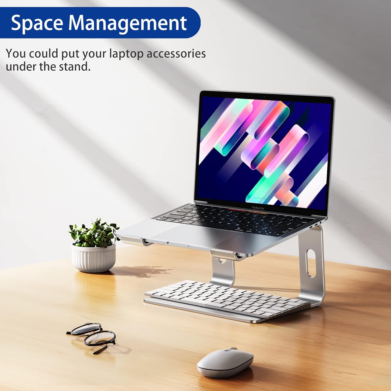 Demonstrates how the laptop stand can help manage desk space by allowing accessories to be stored underneath.