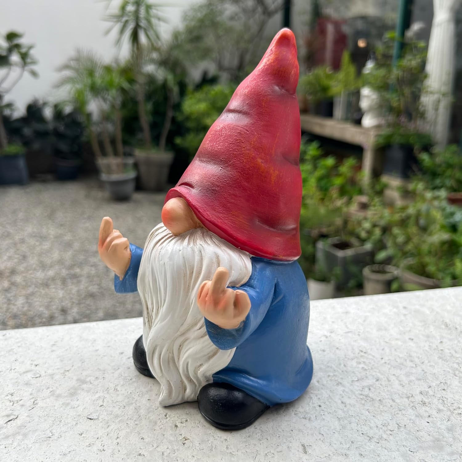 Shows the product in a real-world garden setting to demonstrate how it can be used as outdoor decoration.