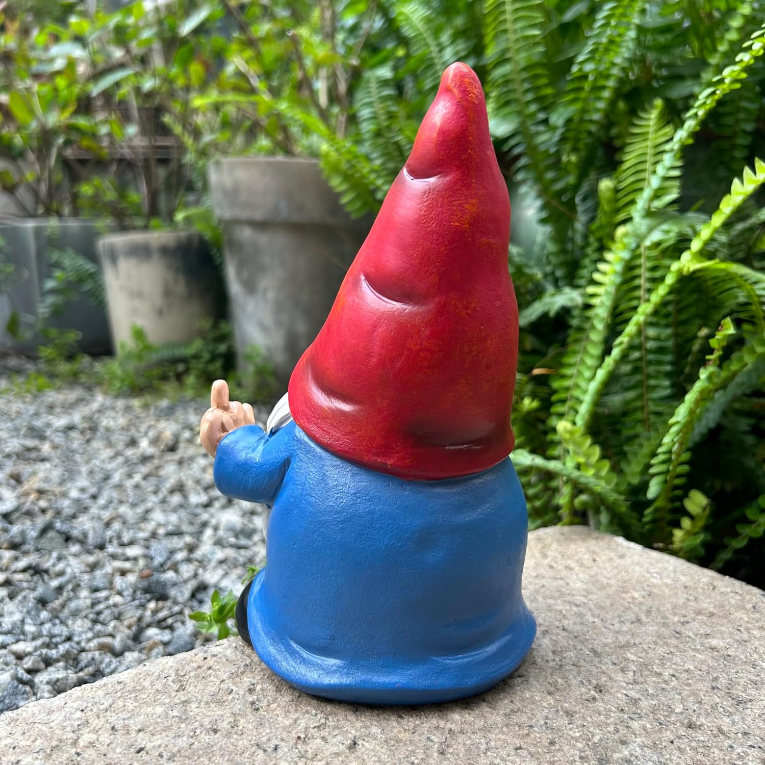 Shows the product in a natural garden setting to demonstrate its use as outdoor decoration.