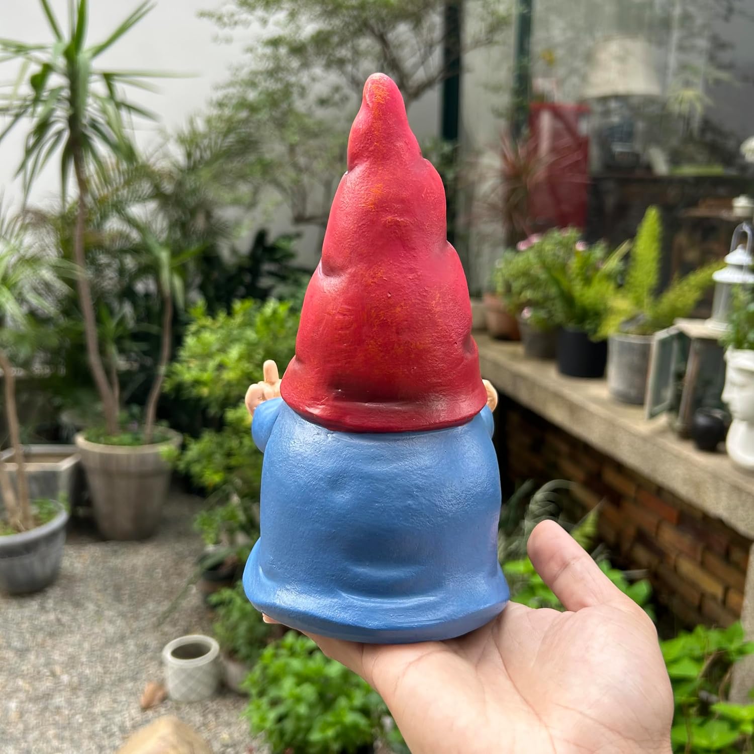 Shows the product in a real-world garden setting to demonstrate its use as outdoor decoration.
