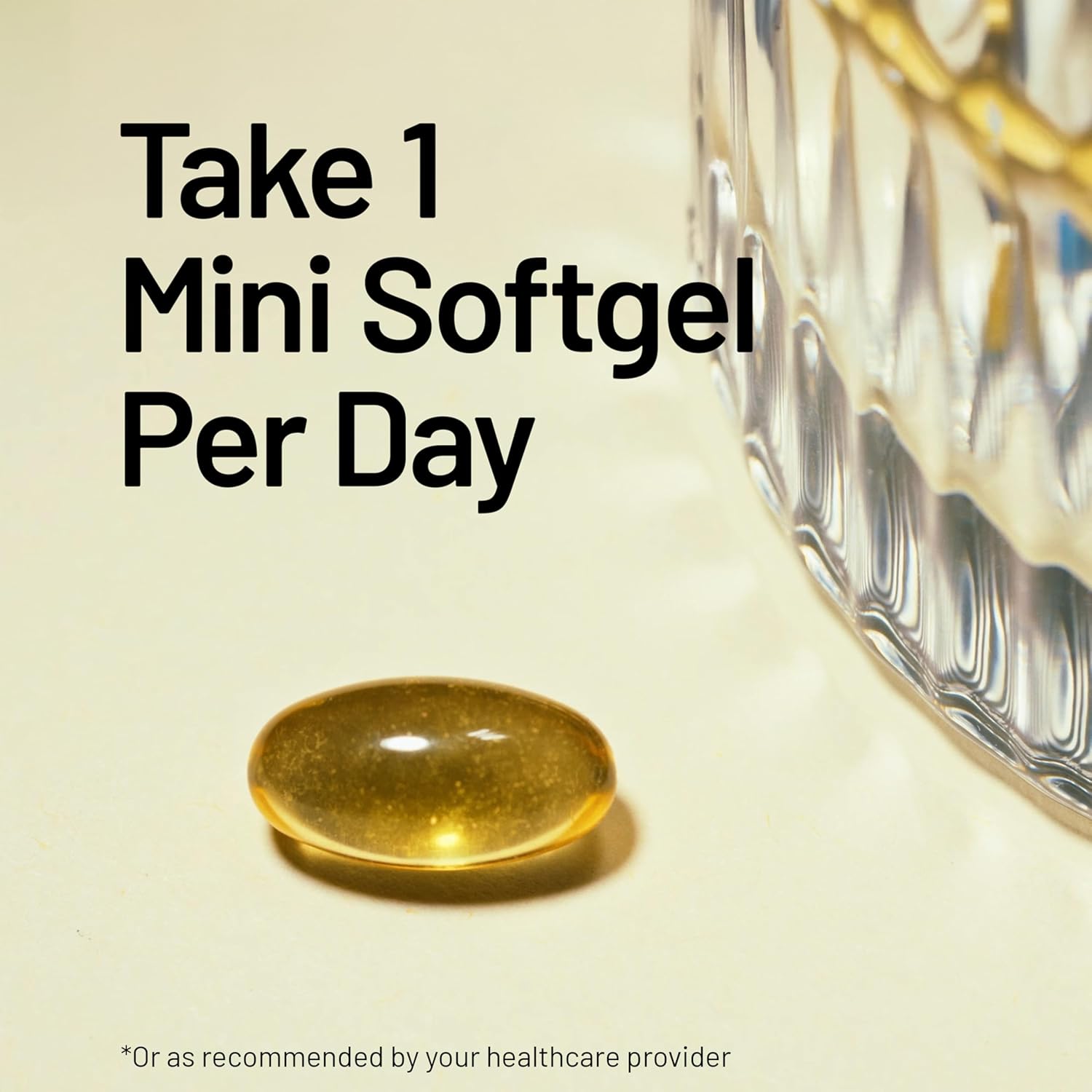 Communicates the simple dosage instructions of taking one mini softgel per day, emphasizing ease of use.