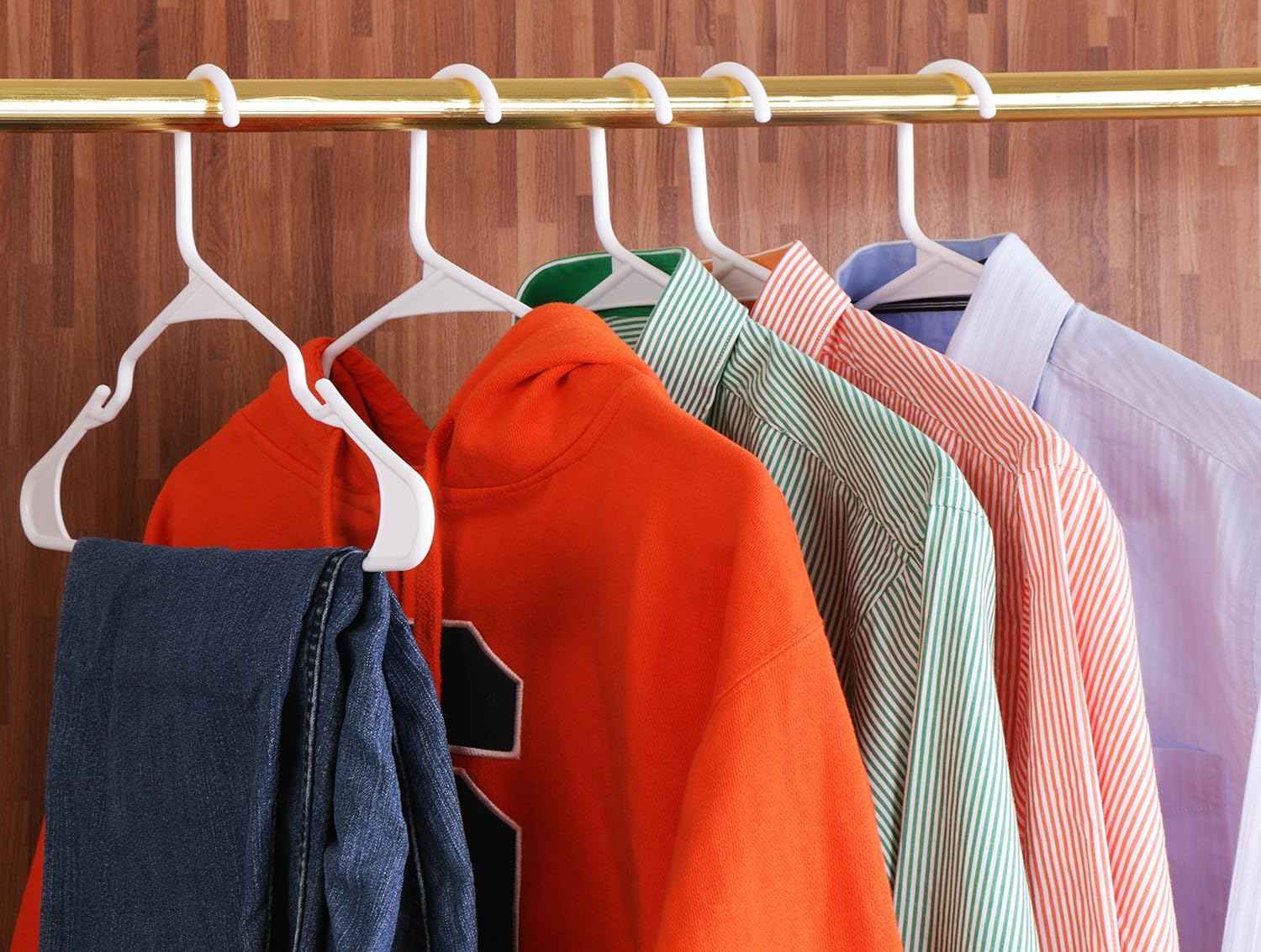 Demonstrates how the hangers can efficiently organize and store multiple clothing items in a compact space.
