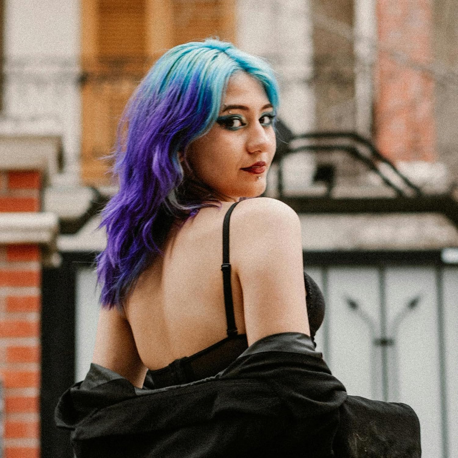 Showcases a real person using the product, demonstrating the vibrant and long-lasting results of the hair dye.