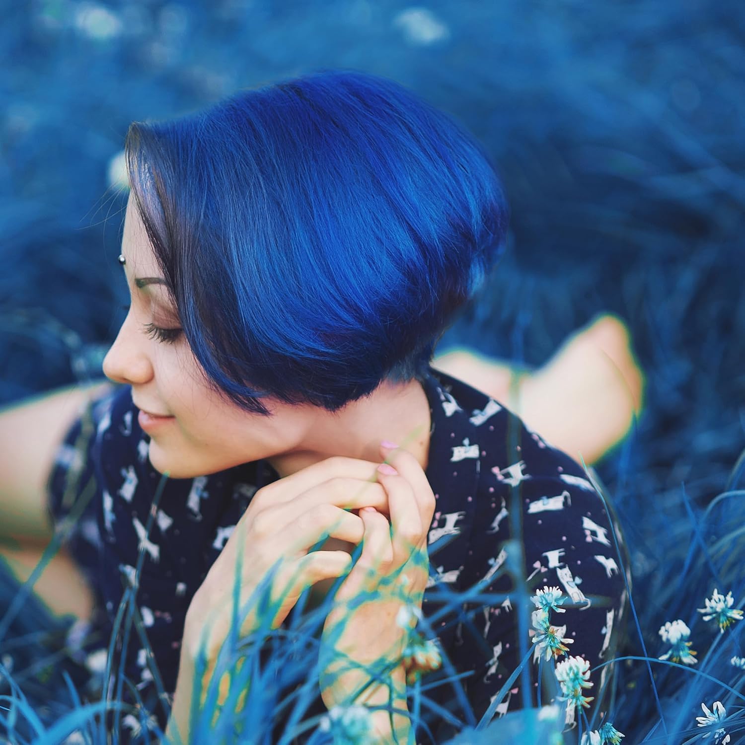 Showcases the vivid blue hair color result in a natural, outdoor setting to demonstrate the product's effectiveness and appeal.
