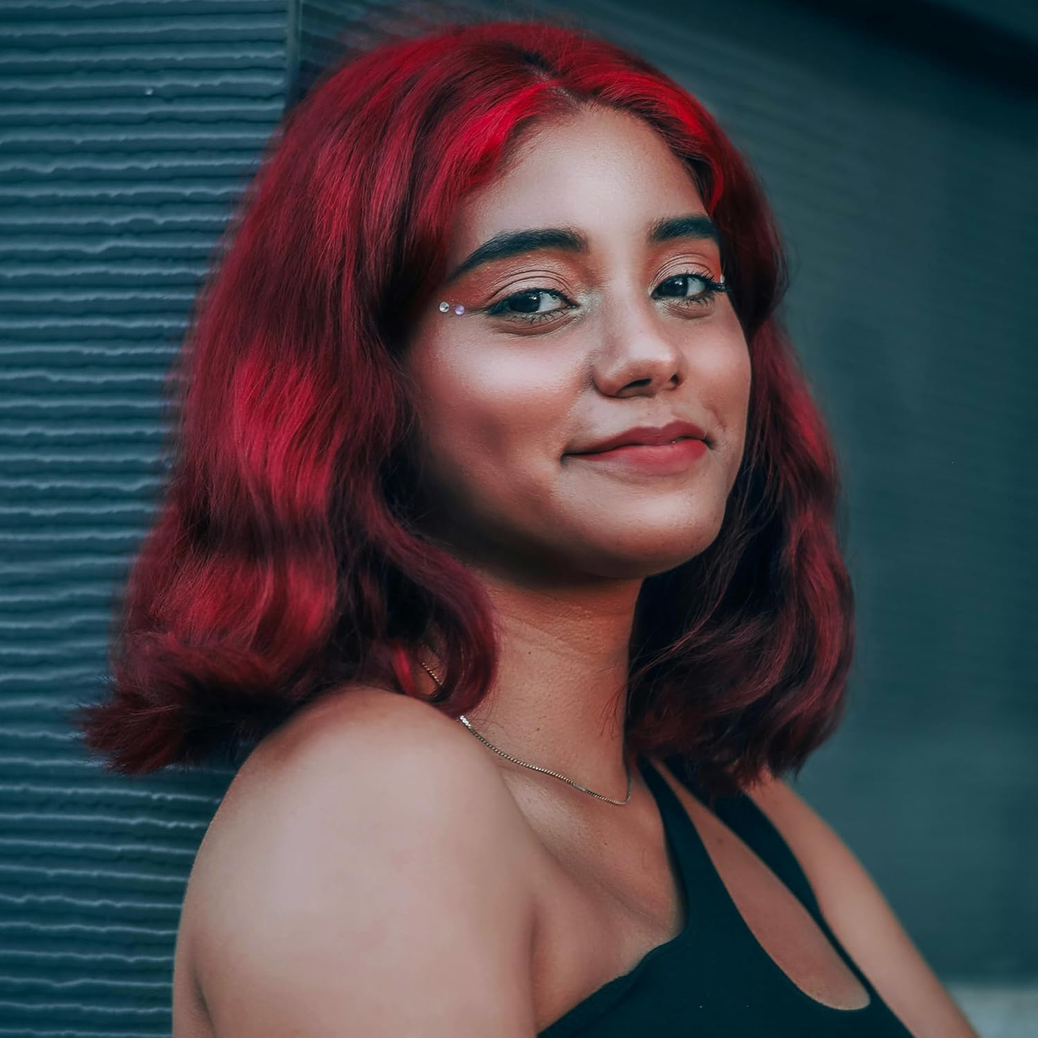 Showcases the vibrant red hair color result, demonstrating the product's ability to create bold, eye-catching hair transformations.