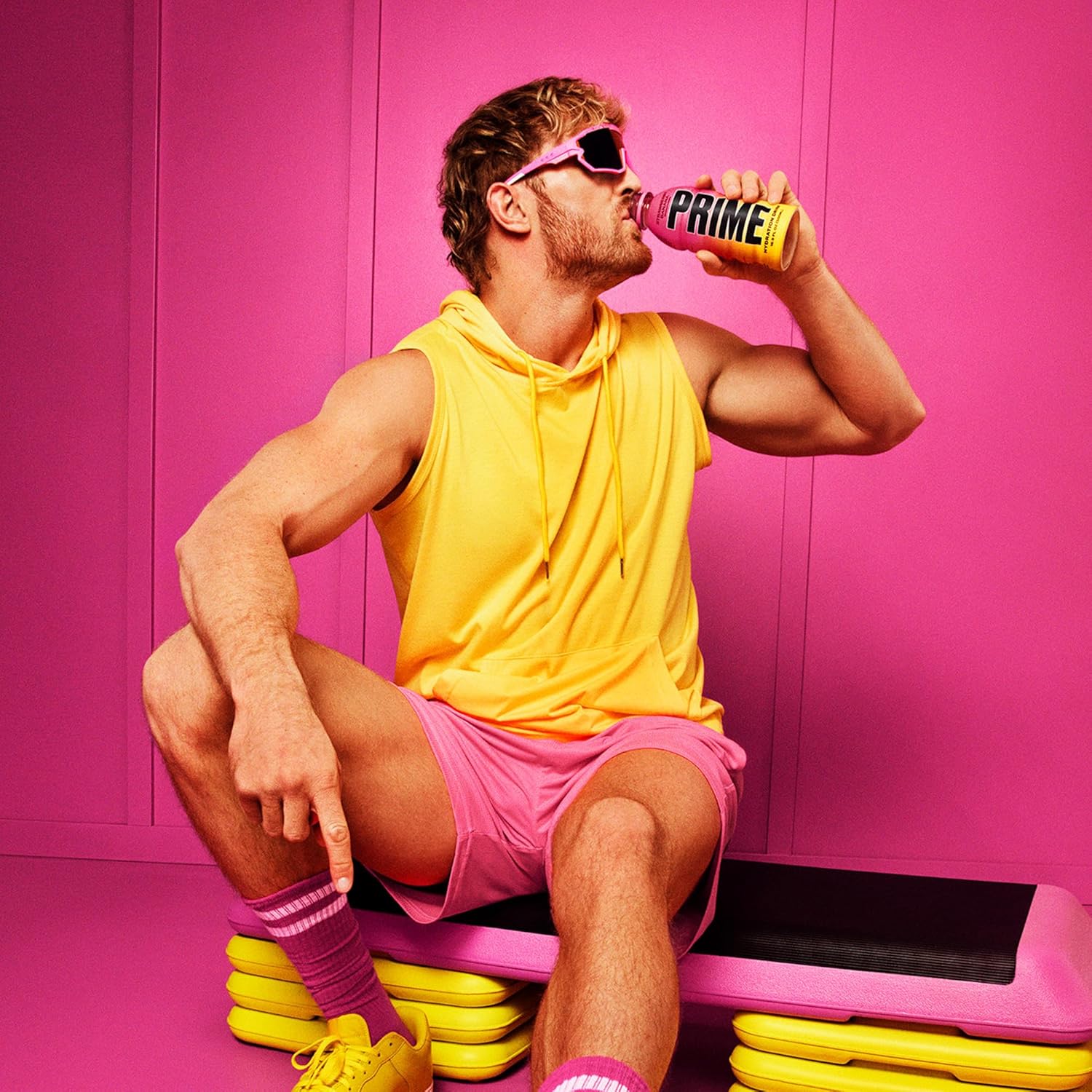 Shows the product being consumed in a vibrant, energetic fitness setting to associate the drink with an active, stylish lifestyle.