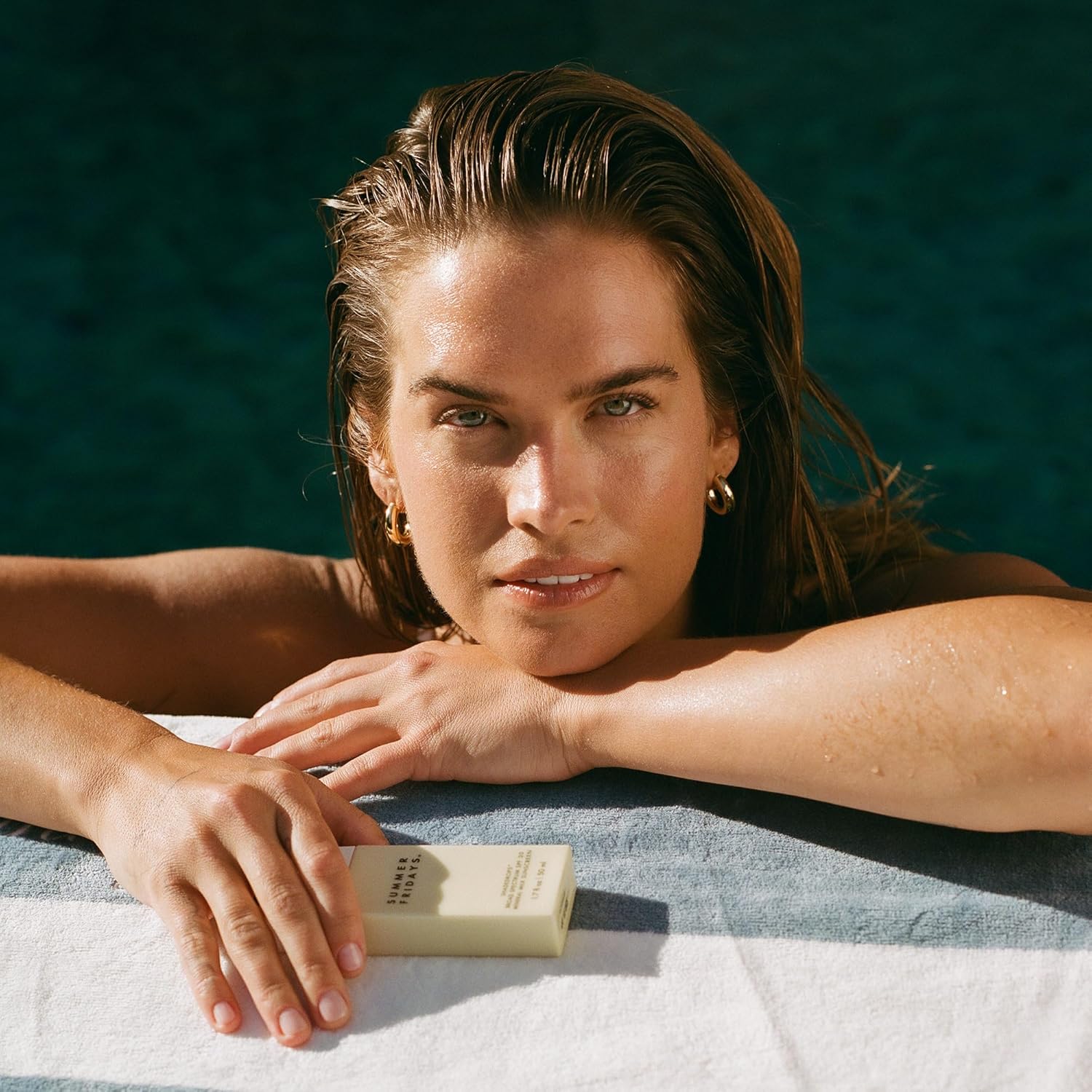 Shows the product in a relaxing, sun-soaked environment to associate it with luxury and self-care.