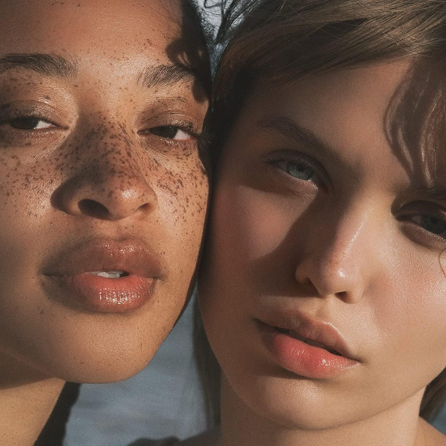 Showcases the product's ability to enhance natural beauty and skin texture across different skin tones.
