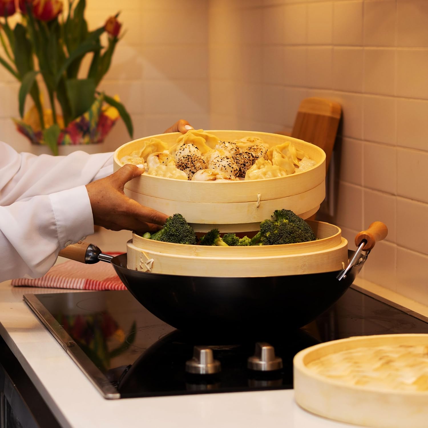 Demonstrates how to use the product for steaming multiple types of food simultaneously, showcasing its versatility and ease of use in cooking.