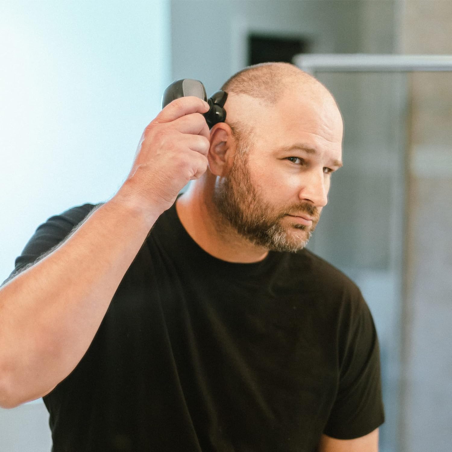 Demonstrates how simple it is to use the product, likely a hair trimmer or grooming device, on oneself. Shows the product being used in a real-life context, emphasizing its practicality for personal…