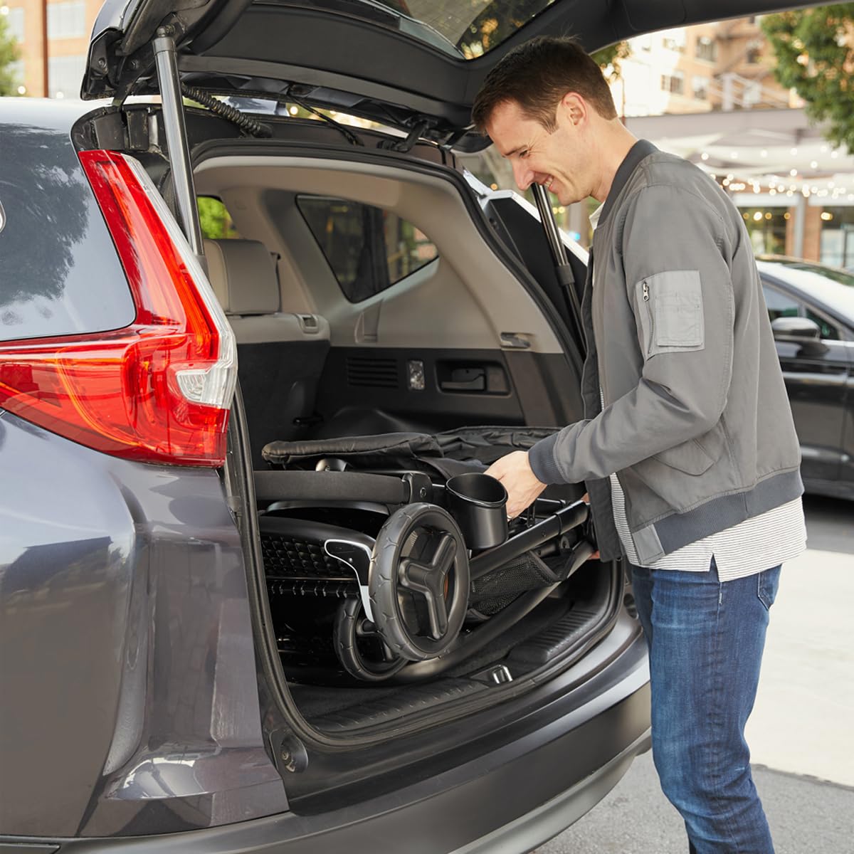 Demonstrates how the product (likely a stroller or baby gear) can be easily folded and stored in a car trunk, highlighting its portability and convenience for travel.