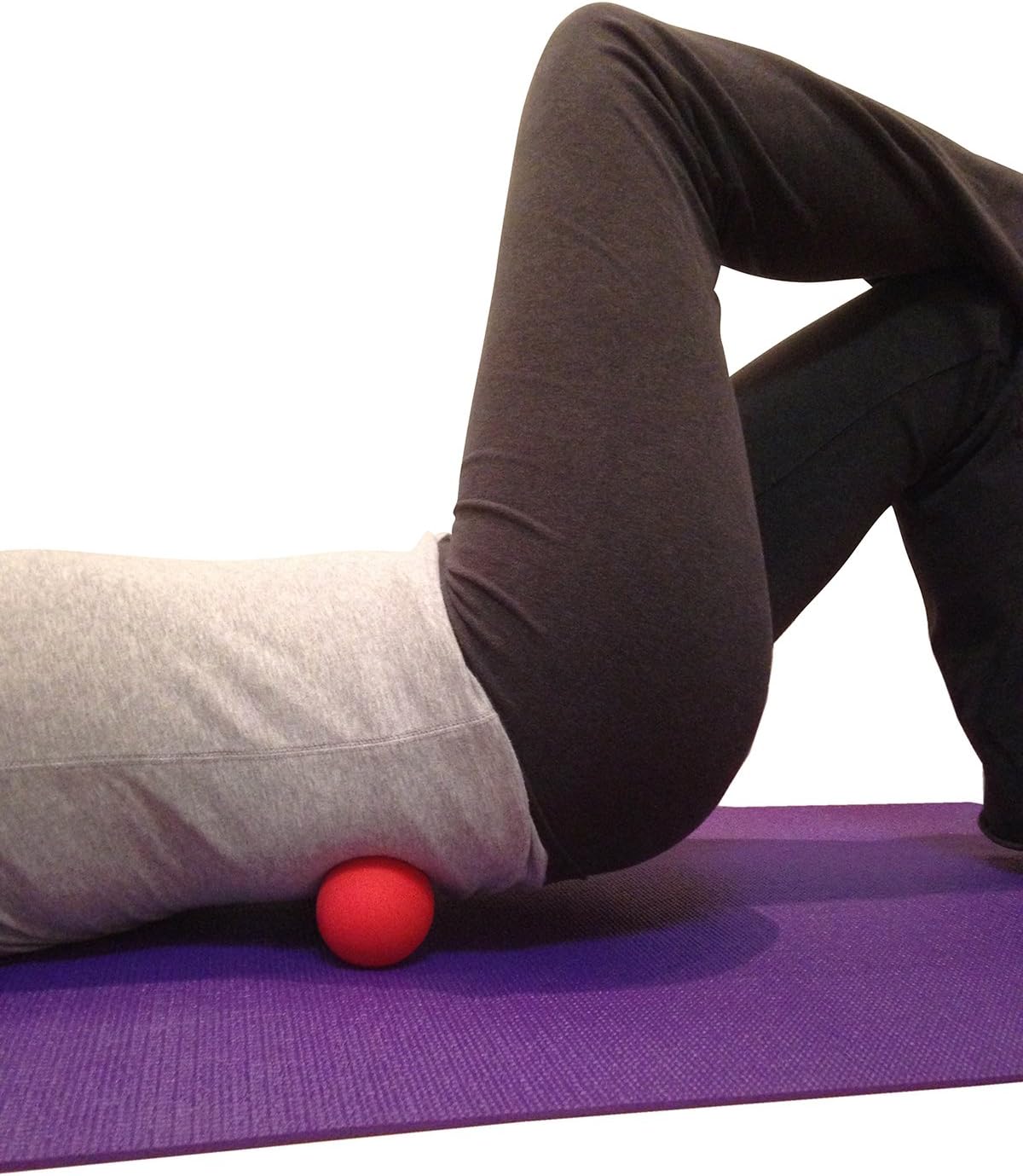 Demonstrates how to use the massage ball for lower back pain relief or muscle tension release.