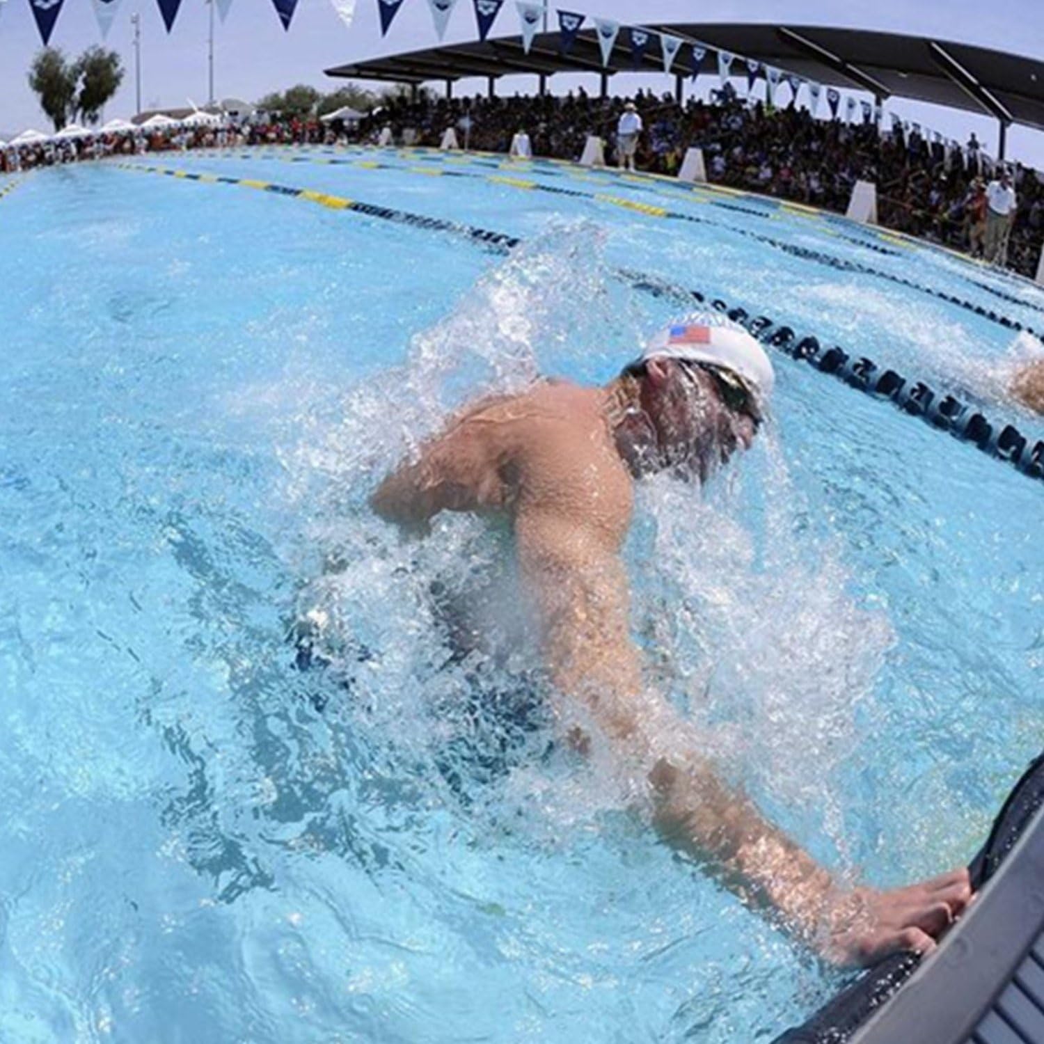 Showcases the product in a real-world competitive swimming context, demonstrating its use in high-performance athletic situations.