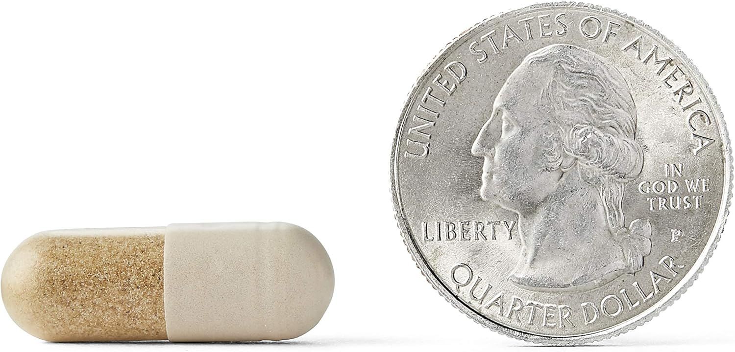 Shows the size of the pill capsule compared to a quarter coin to give shoppers a clear sense of its physical dimensions.