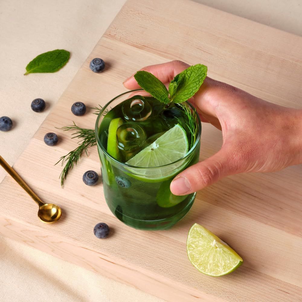 Showcases the various fresh ingredients that can be used to create a green cocktail or mocktail, emphasizing the drink's natural and refreshing qualities.