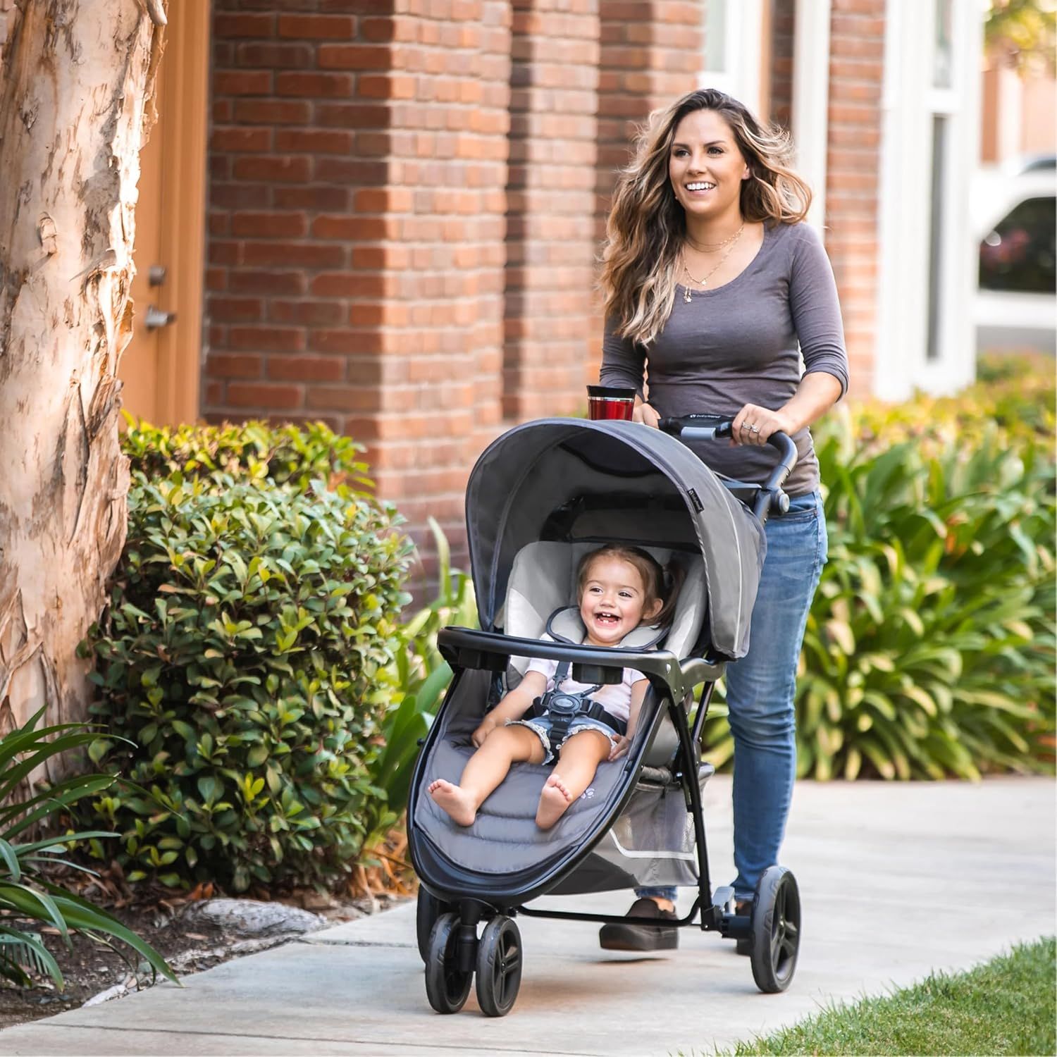 Shows the product being used in a real-world context, demonstrating its practicality for everyday outings with a child.