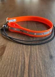 Shows the product in a real-world setting on a wooden surface to give shoppers a sense of the actual appearance and scale of the collars or leashes.