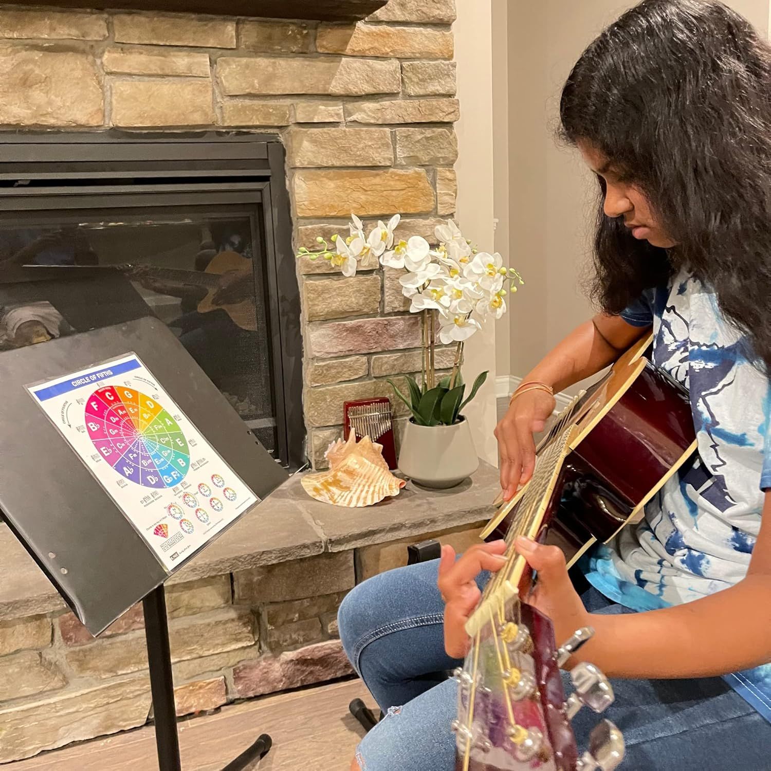 Demonstrates the product being used in a home setting for music education and practice, showing its versatility as a learning tool for guitar players.