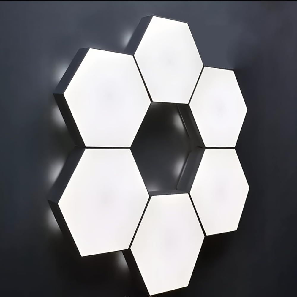 Shows the product installed in a real-world setting to help shoppers visualize how the hexagonal light panels look when mounted on a wall in their own space.